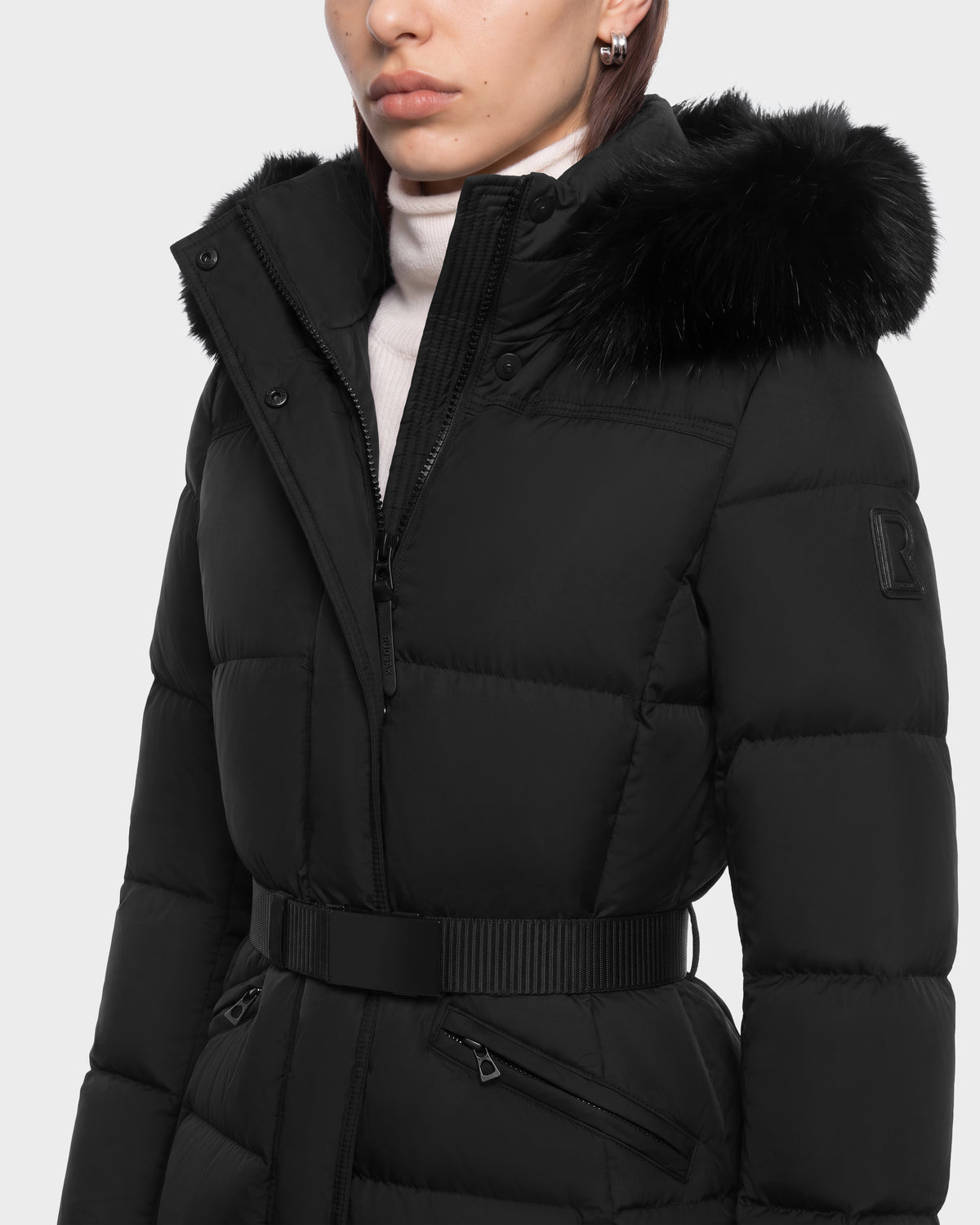 A black Rudsak GRACE FF - 8126535 belted puffer jacket with a faux fur-trimmed hood.