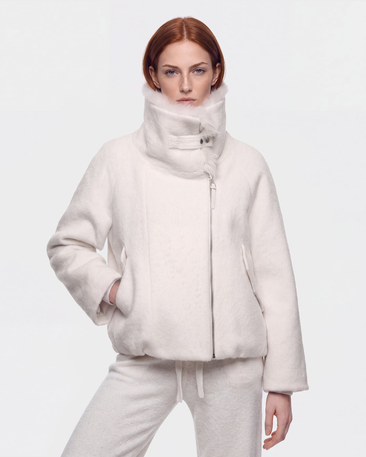 A model wearing a cream-colored, high-collared ZARIA - 8126999 Vanilla winter puffer with faux-fur lining and matching trousers.