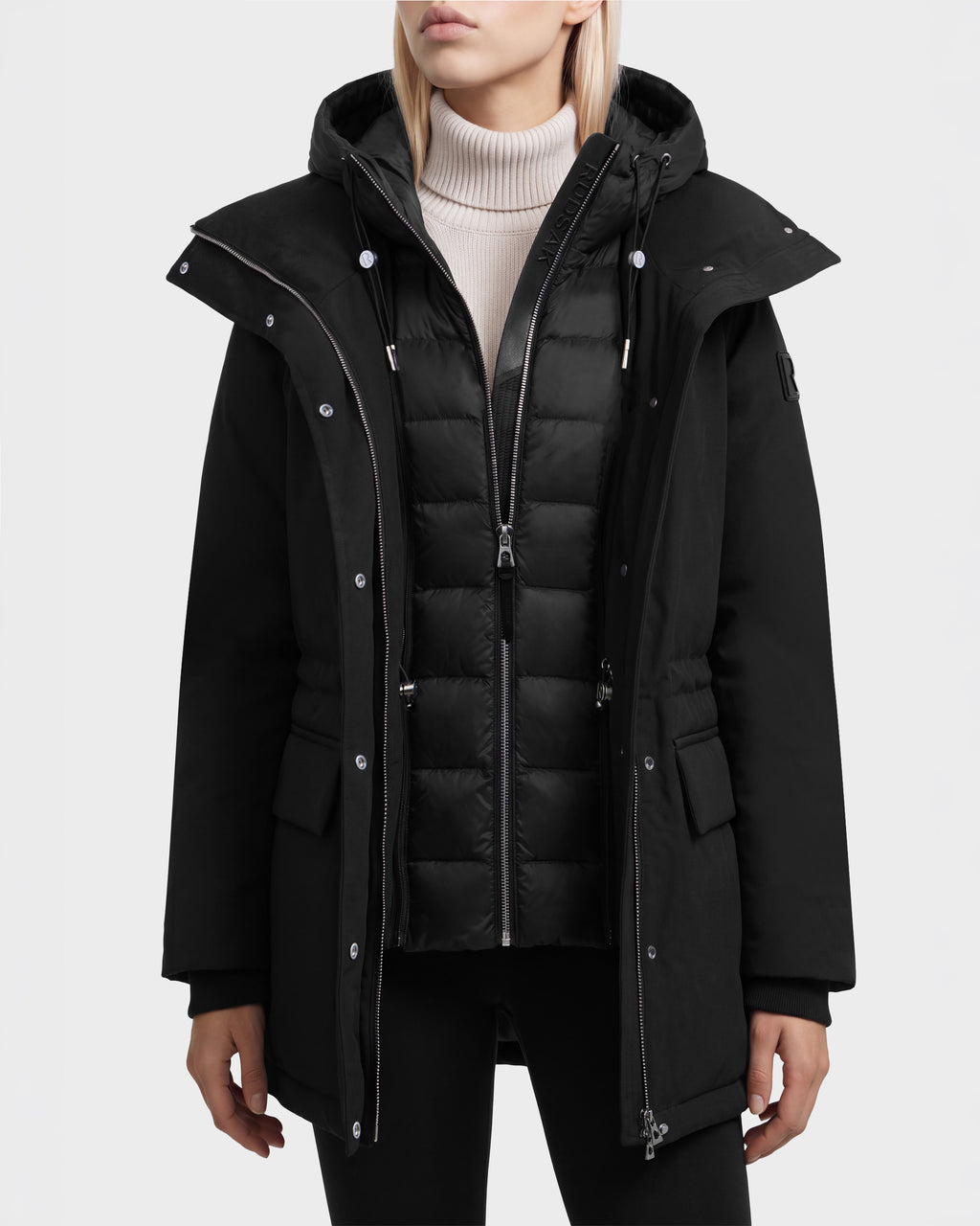 Rudsak BHIMA - 8126515 Black hooded parka with a quilted inner zip-up layer worn over a cream turtleneck sweater.