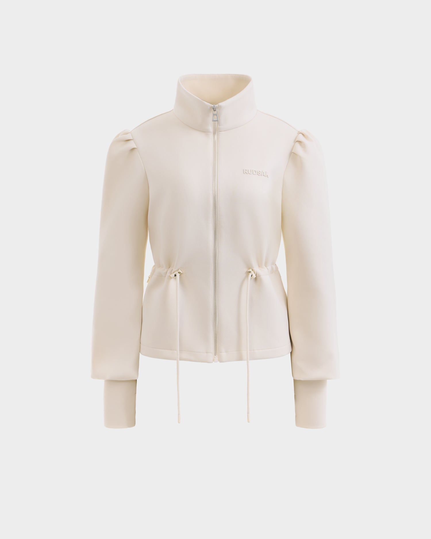 The Rudsak ELODIE - 8526039 Iceland is a cream zip-up sweater jacket with a high collar, puffed sleeves, ribbed cuffs, waist drawstrings, and subtle chest logo—crafted from stretch cotton blend for lightweight comfort.