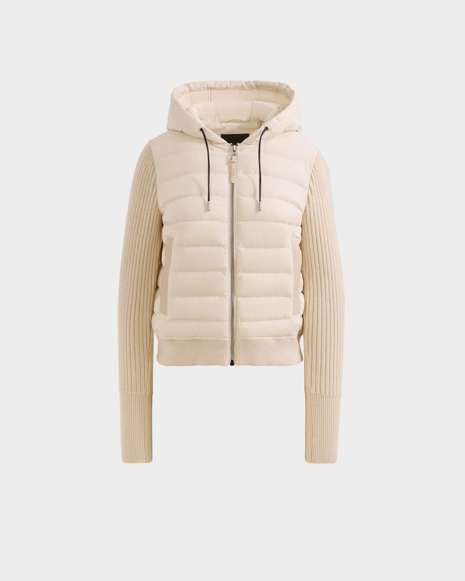 The Rudsak EMILY - L125515 Vanilla is a beige women’s hooded down bomber with a quilted front, ribbed knit sleeves and sides, cropped silhouette, front zipper closure, and drawstring hood, shown against a white background.