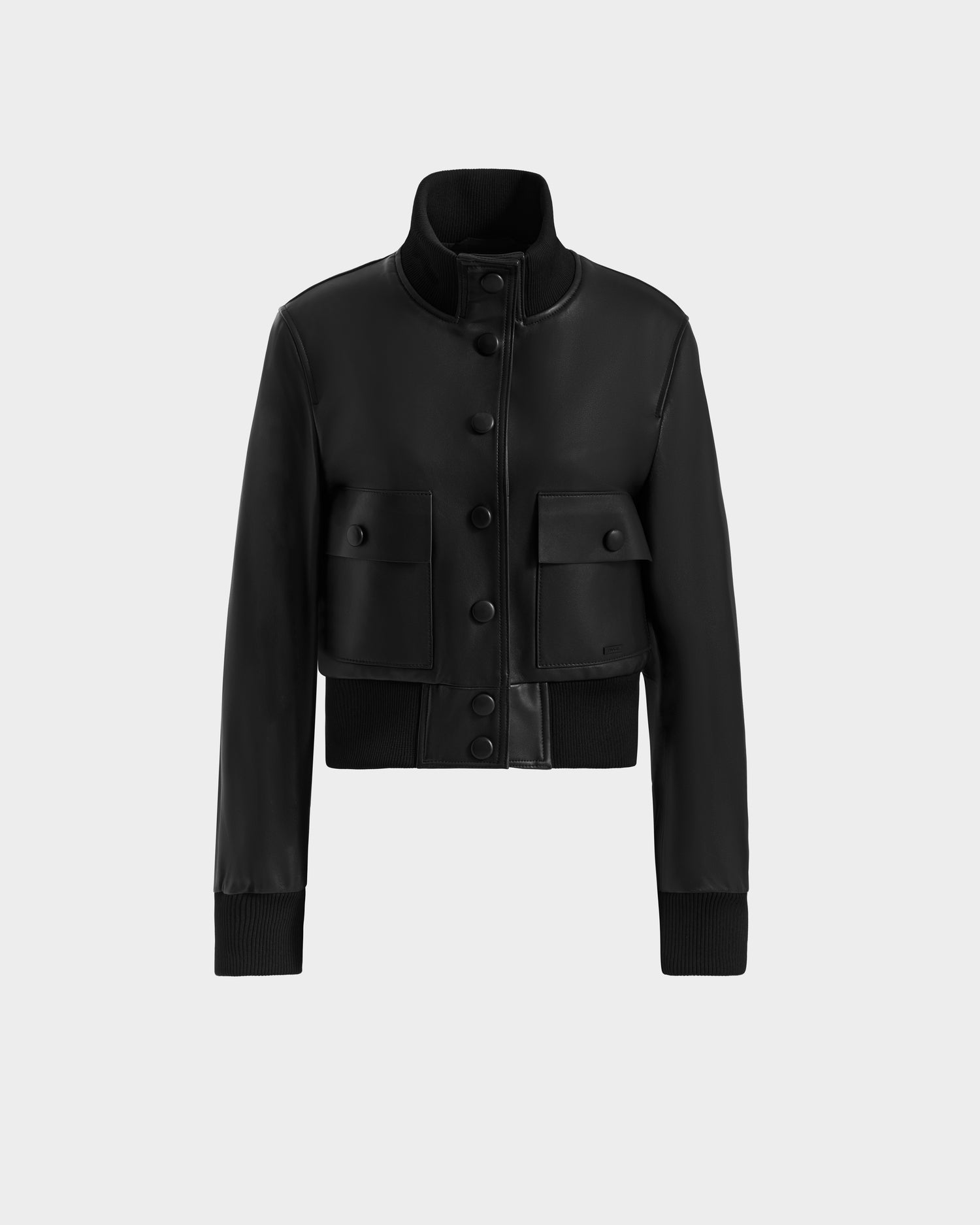 The EVERLEIGH - 8125547 Black by Rudsak is a women’s leather bomber jacket with a high collar, button closure, ribbed cuffs and hem, and two large front pockets with buttoned flaps, shown on a plain light background.