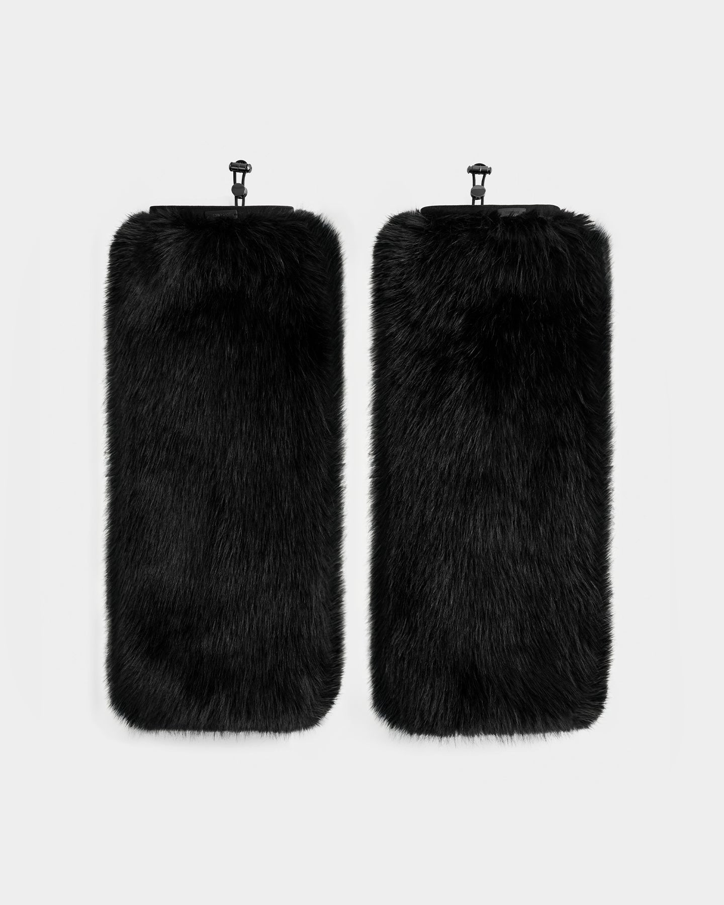 Rudsak’s PAIGE - 8425534 Black: a pair of rectangular black faux fur leg warmers with soft, fluffy texture and top black clips—an on-trend winter accessory or après-ski statement, shown side by side on a white background.