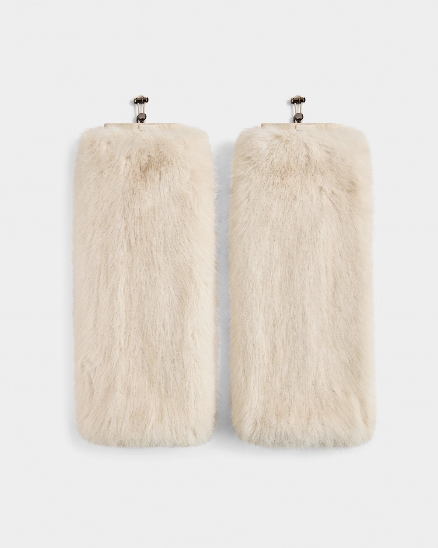 Two rectangular PAIGE - 8425534 Vanilla faux fur clutches by Rudsak feature cream color and metal frame clasps, exuding après-ski chic—the perfect women’s winter accessory. Both are shown side by side on a white background.