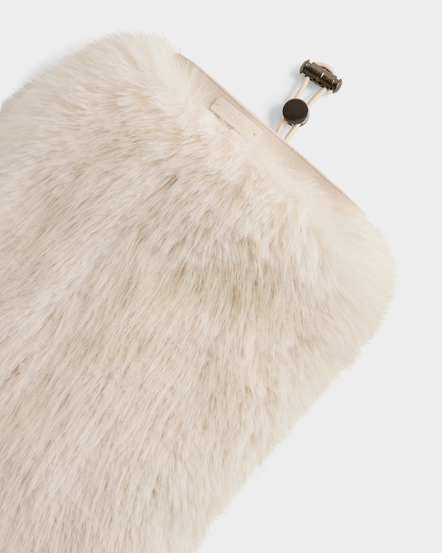 A close-up of the Rudsak PAIGE - 8425534 Vanilla plush, cream-colored faux fur hot water bottle cover with a metallic cap showcases this chic women’s winter accessory against a plain white background.
