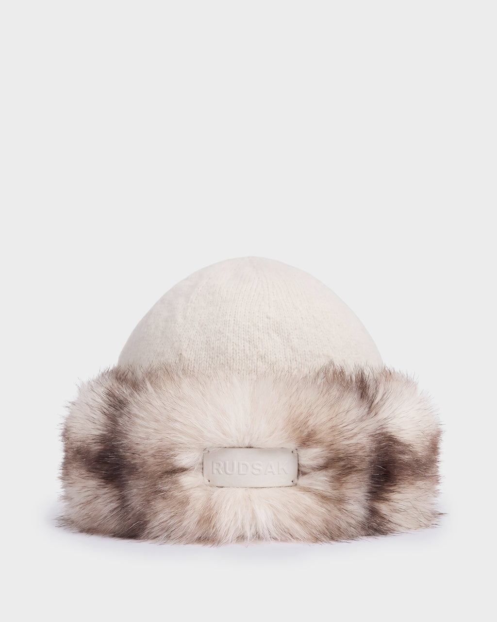 Vanilla-colored LORETTA W - 8426510 RUDSAK knit beanie with a wide, variegated faux fur trim and a branded leather patch on the front.