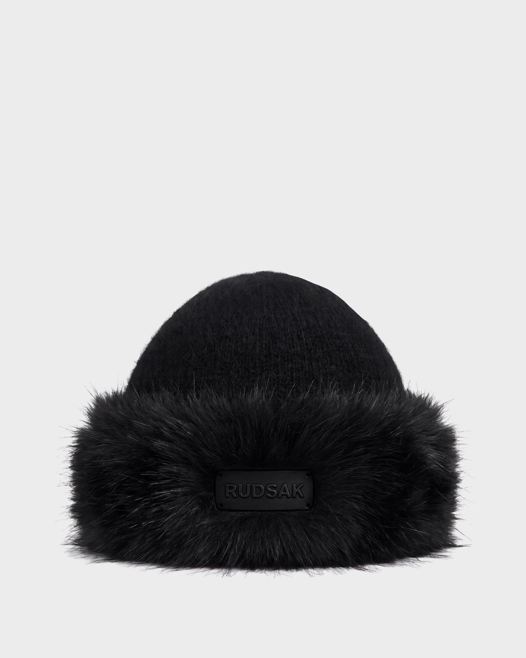 Black LORETTA W - 8426510 RUDSAK knit beanie with a wide faux fur brim and a branded rectangular patch on the front.