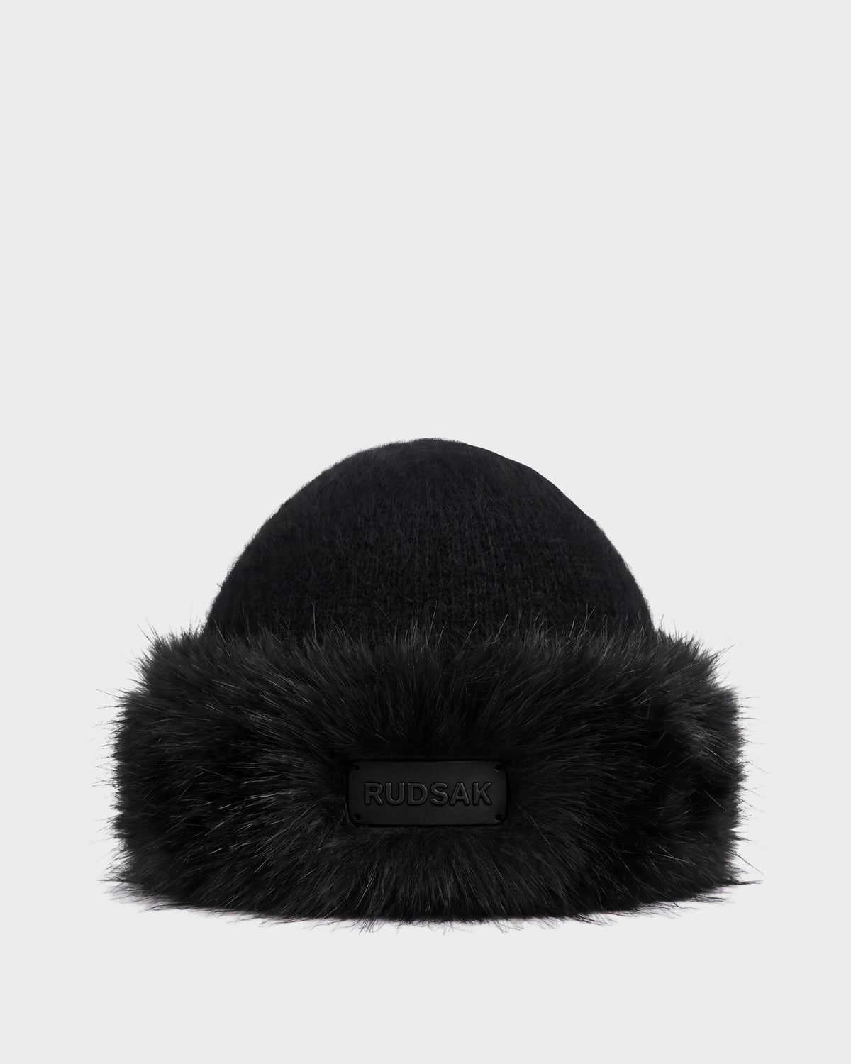 Black LORETTA W - 8426510 RUDSAK knit beanie with a wide faux fur brim and a branded rectangular patch on the front.