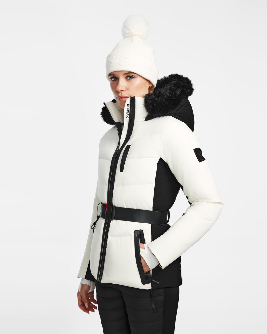 A woman in the Rudsak ALAIA - 8124816 Iceland womens quilted ski jacket with a chic white and black design.