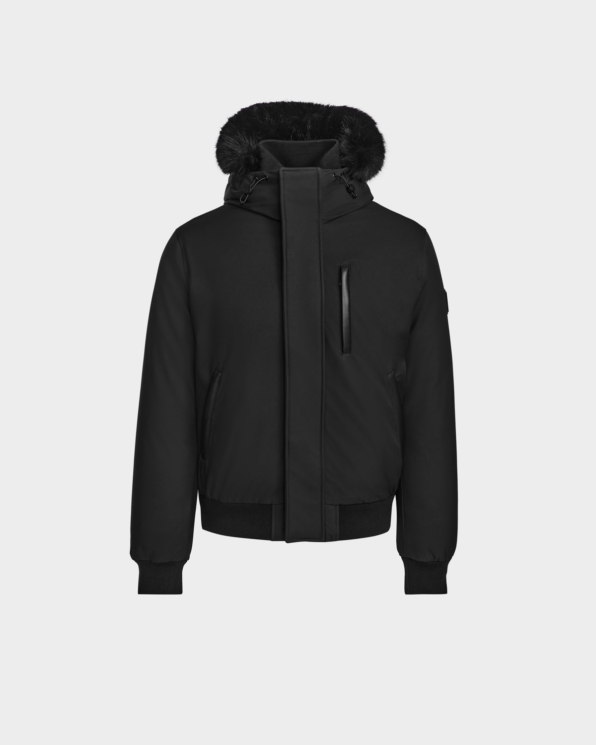 The Rudsak DEACON - M123513 Black/Black mens winter coat features a black hood, fur-lined hood, front zip with flap, ribbed cuffs and hem, zippered chest pocket, and recycled leather trim, shown on a plain white background.