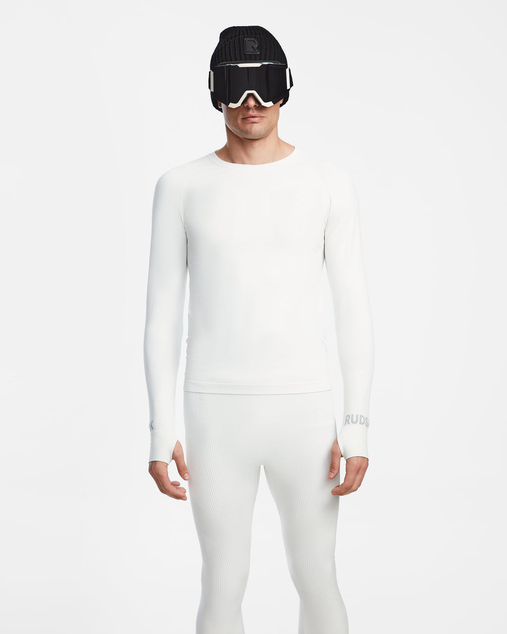 A person faces forward wearing the Rudsak FRANC - 6524541 Iceland fitted, all-white men’s thermal underwear set, paired with a black knit hat and white ski goggles, against a plain white background.