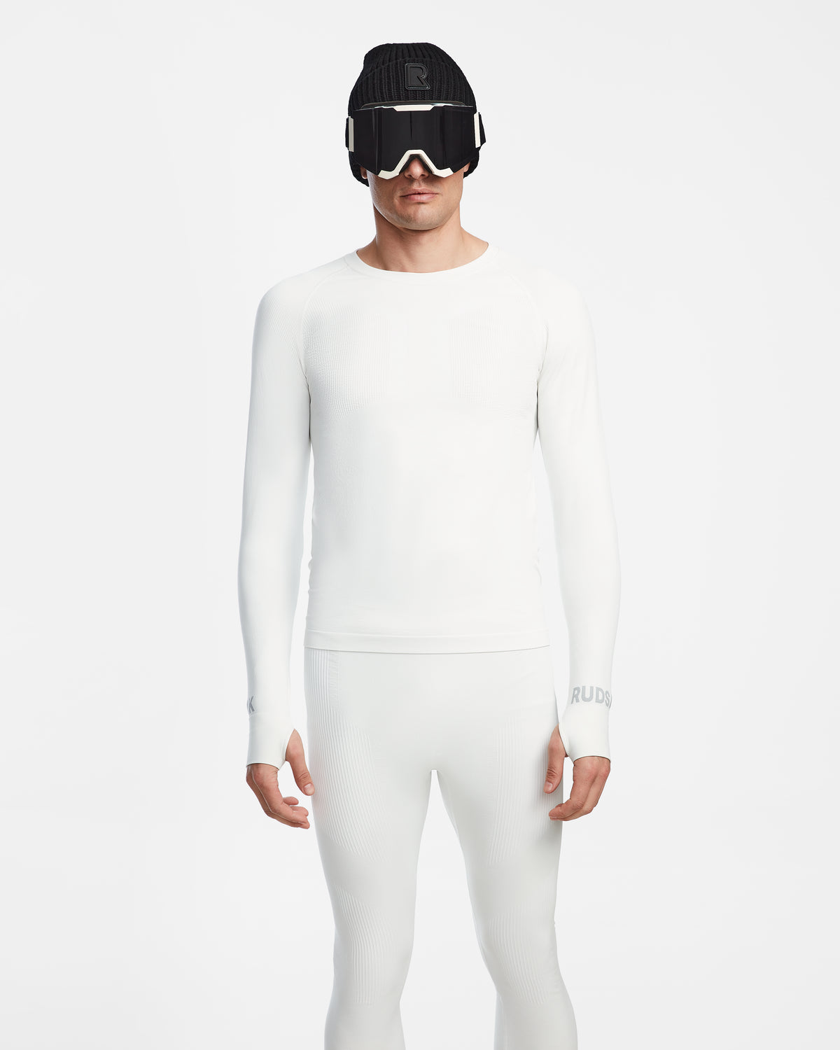A person faces forward wearing the Rudsak FRANC - 6524541 Iceland fitted, all-white men’s thermal underwear set, paired with a black knit hat and white ski goggles, against a plain white background.