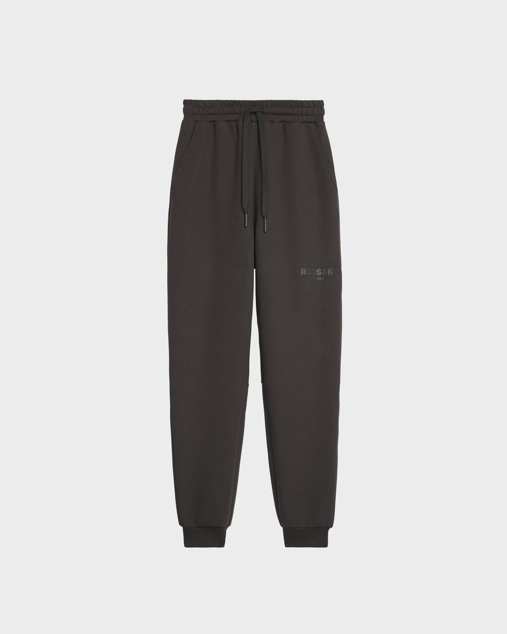 Rudsak’s JOSS - 9524009 Grey M joggers feature premium cotton, an elastic waistband with drawstring, cuffed ankles, and subtle left thigh text, showcased against a plain white background for a stylish look.
