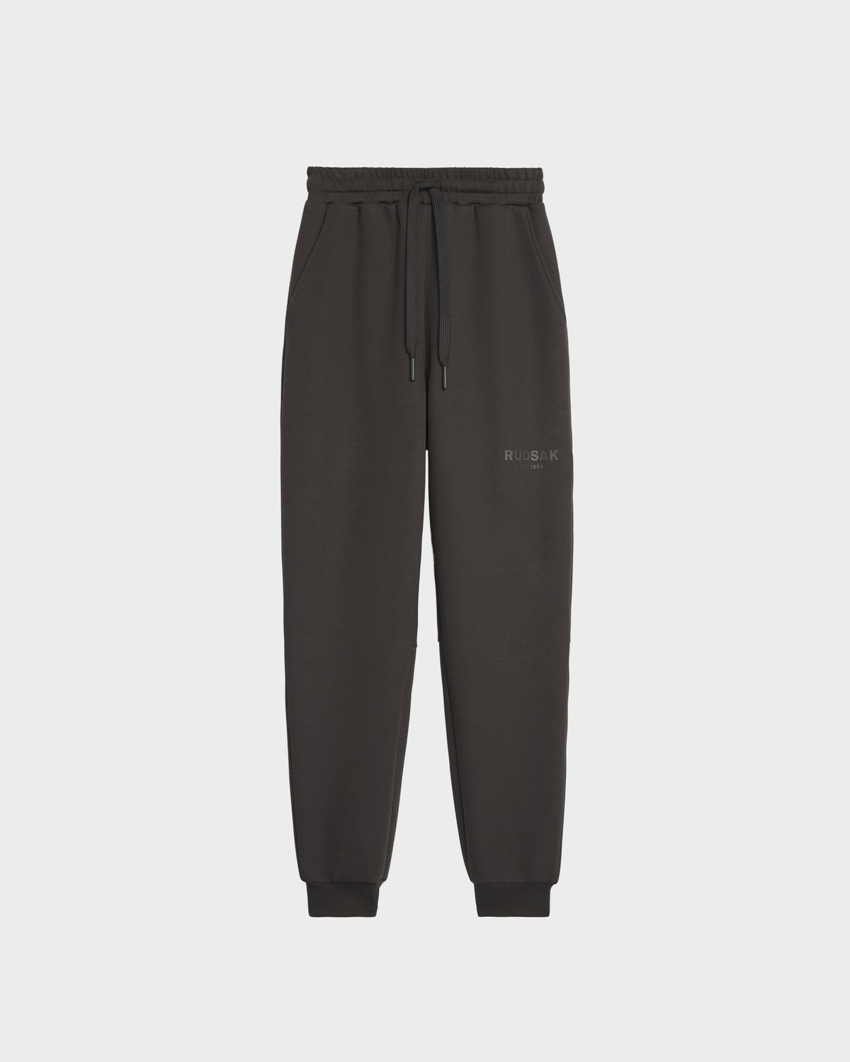 Rudsak’s JOSS - 9524009 Grey M joggers feature premium cotton, an elastic waistband with drawstring, cuffed ankles, and subtle left thigh text, showcased against a plain white background for a stylish look.