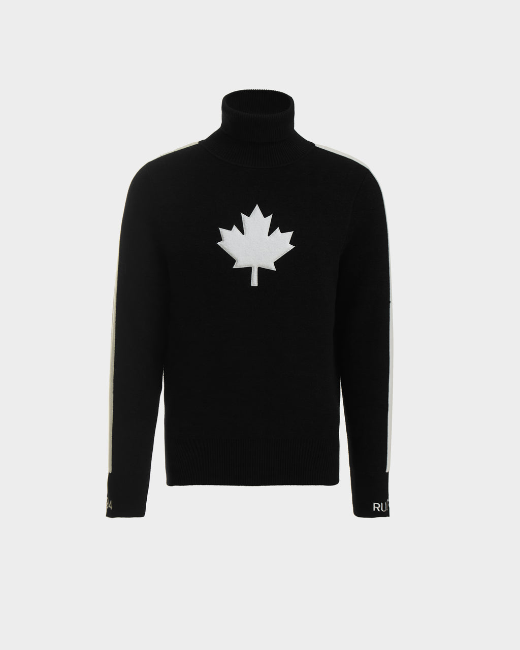 The LUKAS - 6524543 Black by Rudsak is a mens knit turtleneck sweater with a bold white maple leaf emblem and white sleeve stripes—ideal for winter sports or stylish après-ski gatherings.