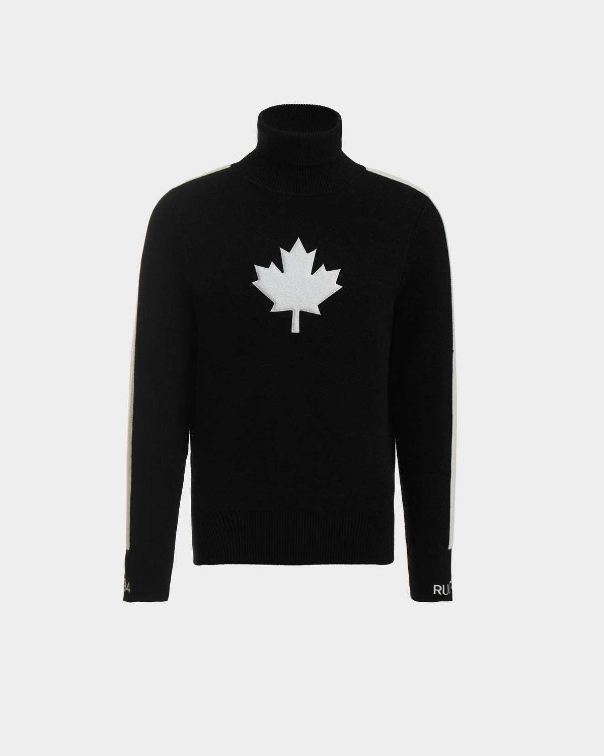 The LUKAS - 6524543 Black by Rudsak is a mens knit turtleneck sweater with a bold white maple leaf emblem and white sleeve stripes—ideal for winter sports or stylish après-ski gatherings.