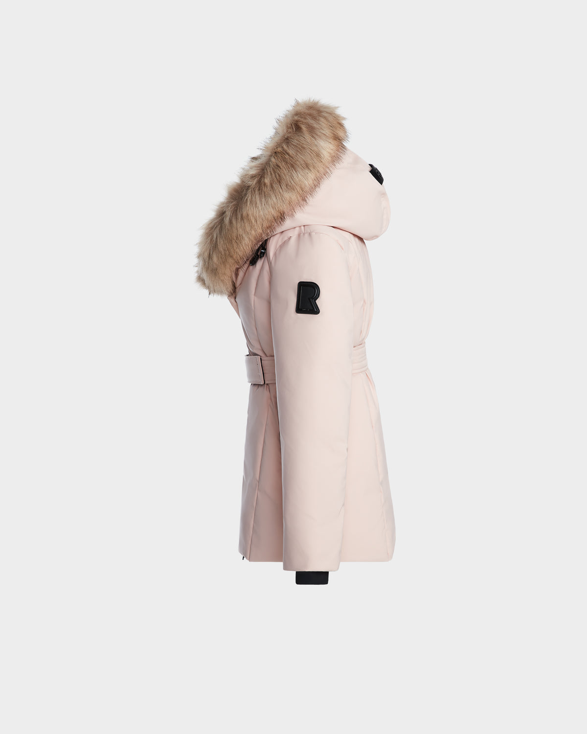 The Rudsak MODA K - 0124505 Pastel Pink is a light pink girls down parka made from recycled nylon, with a fur-lined hood, black sleeve patch, and belted waist, shown in side profile on a plain white background.