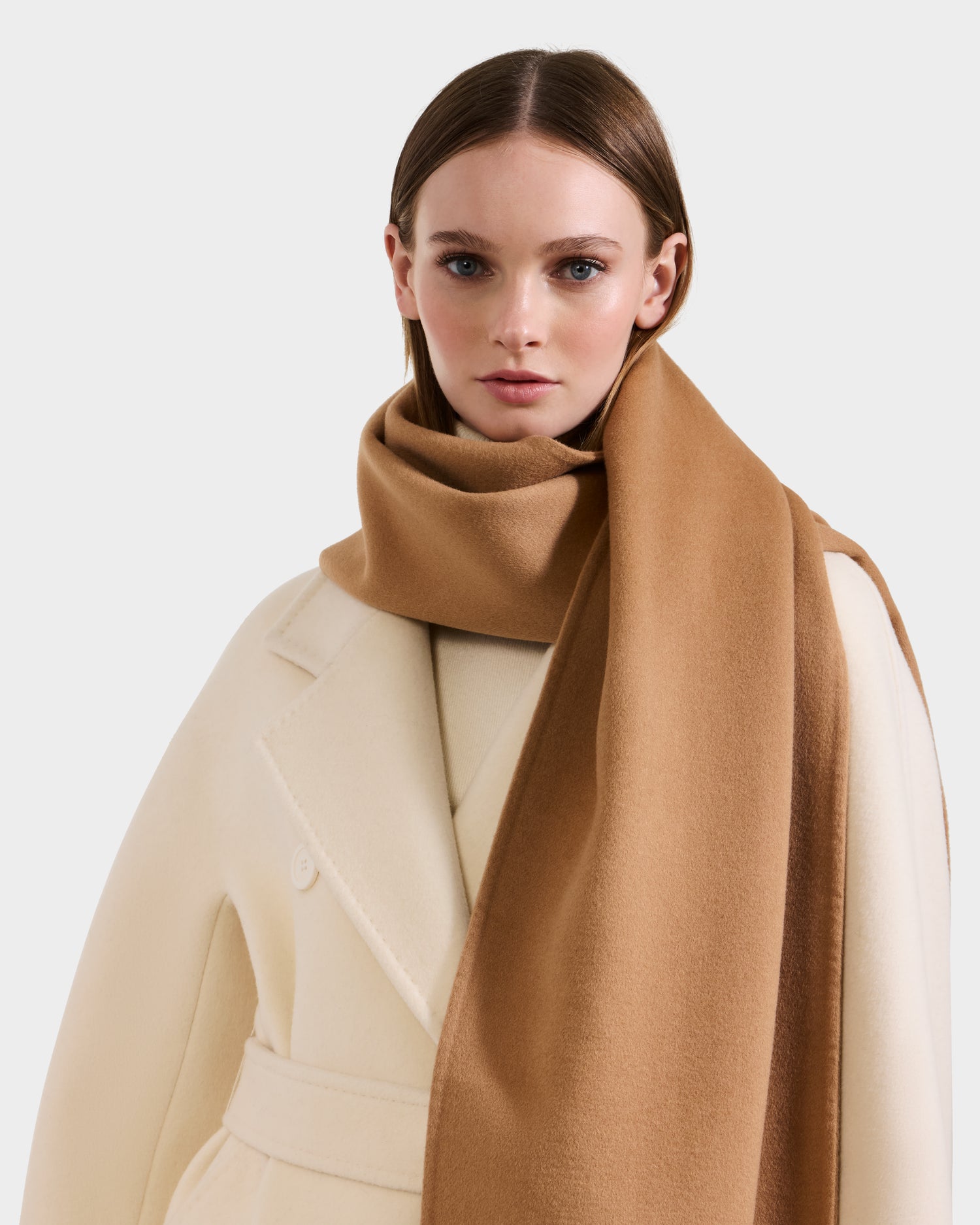 A woman in a cream belted coat and a large camel CALEN - 8425532 scarf by Rudsak stands against a plain light background.