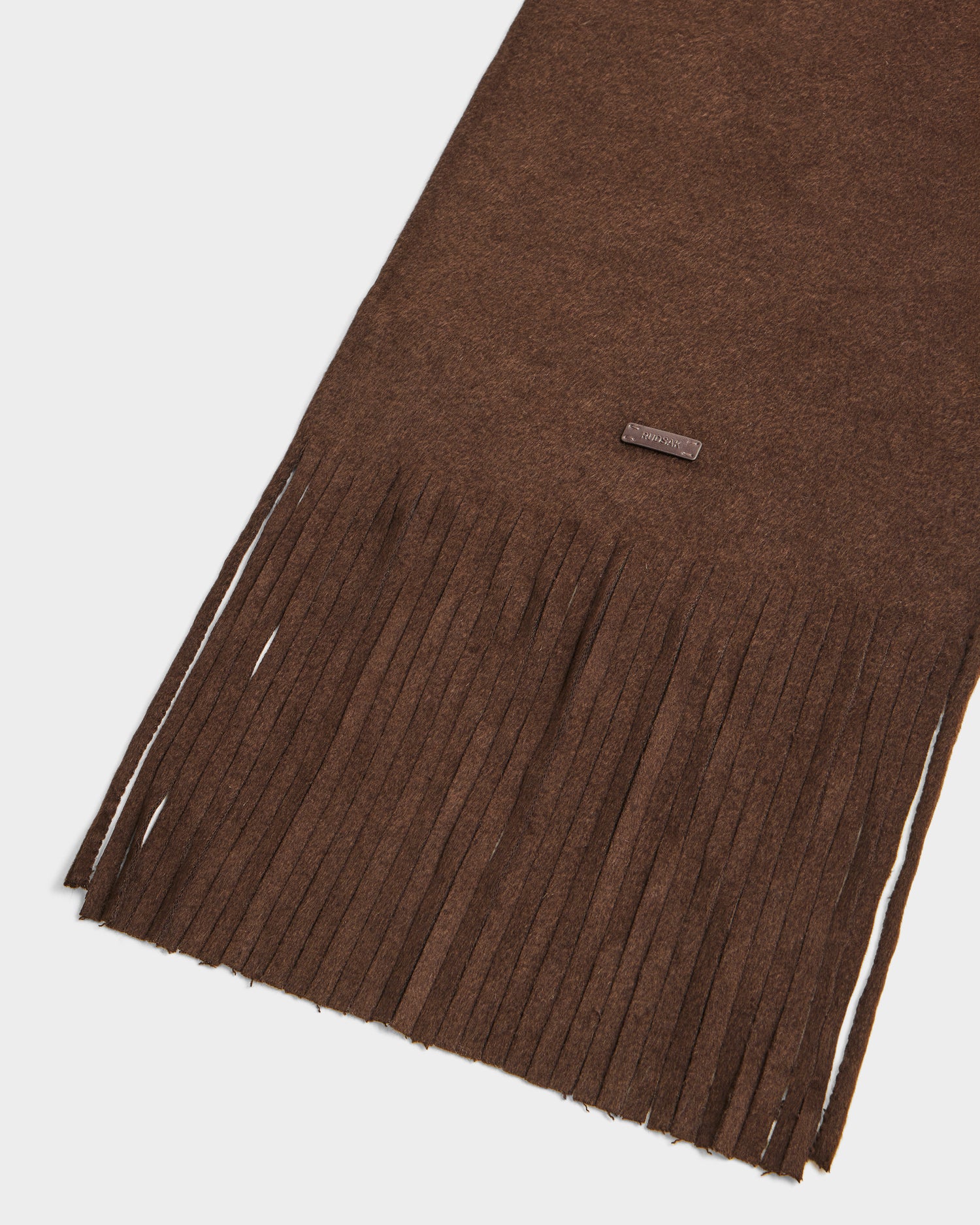 The CALEN - 8425532 Espresso by Rudsak is a unisex wool blend scarf with brown fringe, making it an essential cold-weather accessory.