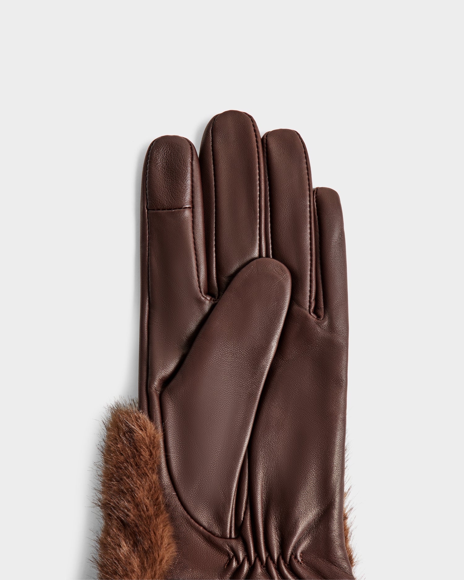 The Rudsak COVE - 8425533 Mocha glove, featuring smooth brown leather and faux fur trim at the wrist, is positioned palm-up against a light gray background to highlight its texture and gathered stitching.