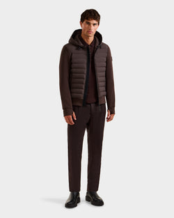 A young man faces forward, wearing the Rudsak DEE MAT - 6124028 Espresso men's lightweight hybrid down jacket, paired with dark brown pants, a matching shirt, and black shoes against a plain white background.