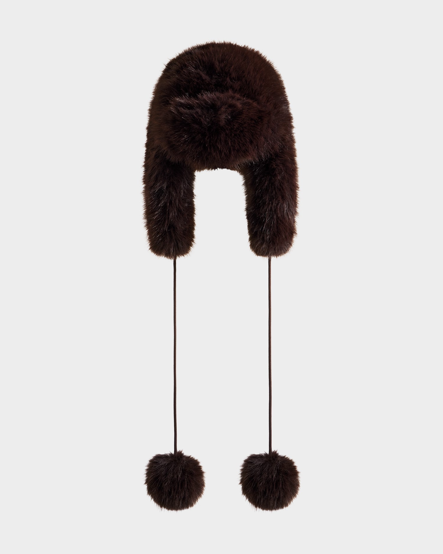 The DEMI - L425539 Espresso by Rudsak is a dark brown women's faux-fur aviator hat with ear flaps and pom-pom strings, shown on a plain light background—the perfect stylish and warm winter accessory.