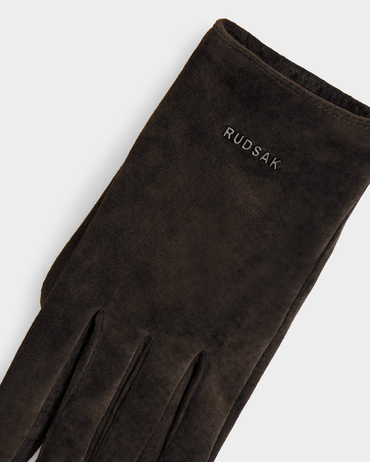 A close-up of the FLORA - L425542 Espresso women’s suede glove by Rudsak, featuring white brand embroidery near the wrist; this elegant winter glove is displayed against a plain white background.