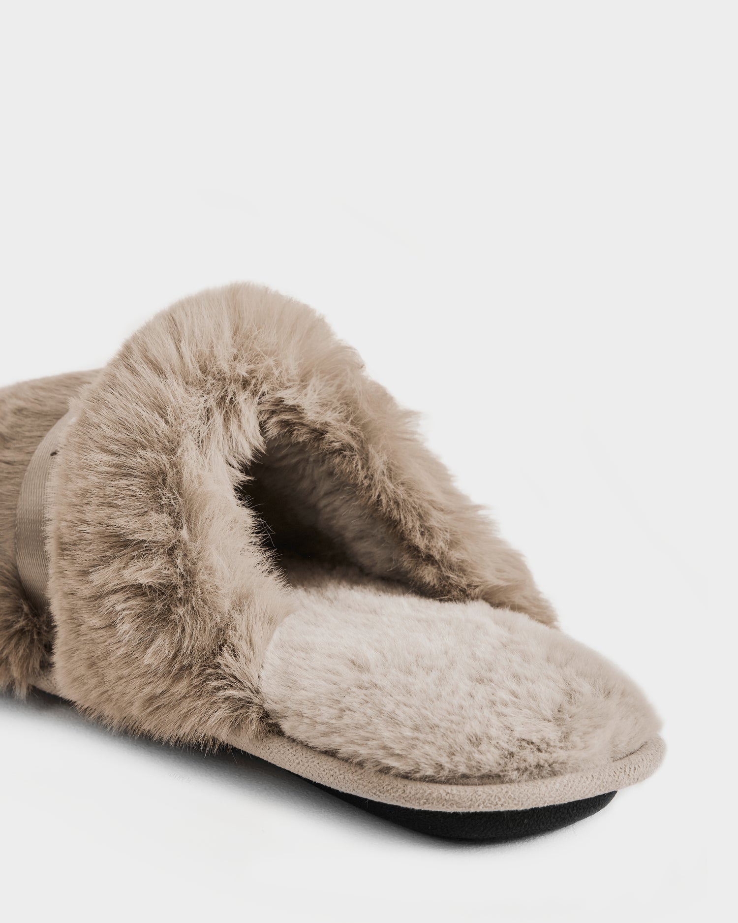 A close-up of the Rudsak FLUFF - L223509 Almond women’s slipper, featuring a fuzzy beige exterior, fluffy interior, and open back, displayed against a plain white background.