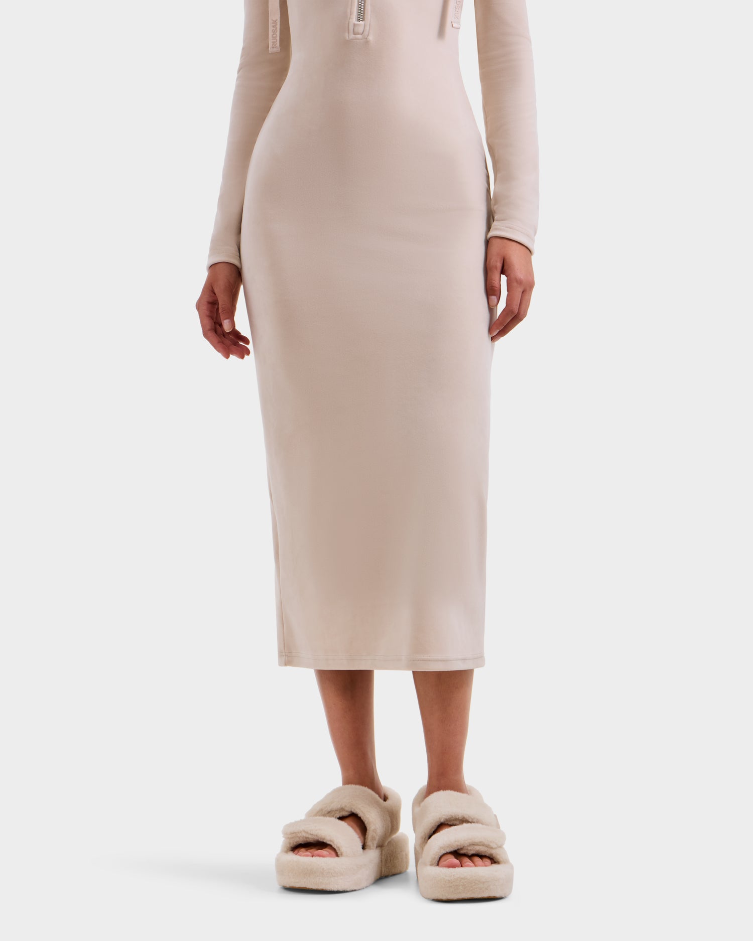 A person wearing a fitted, long-sleeve Rudsak women’s midi dress and ISABELLA - L525502 Cream fluffy platform sandals, shown from shoulders down against a plain white background.