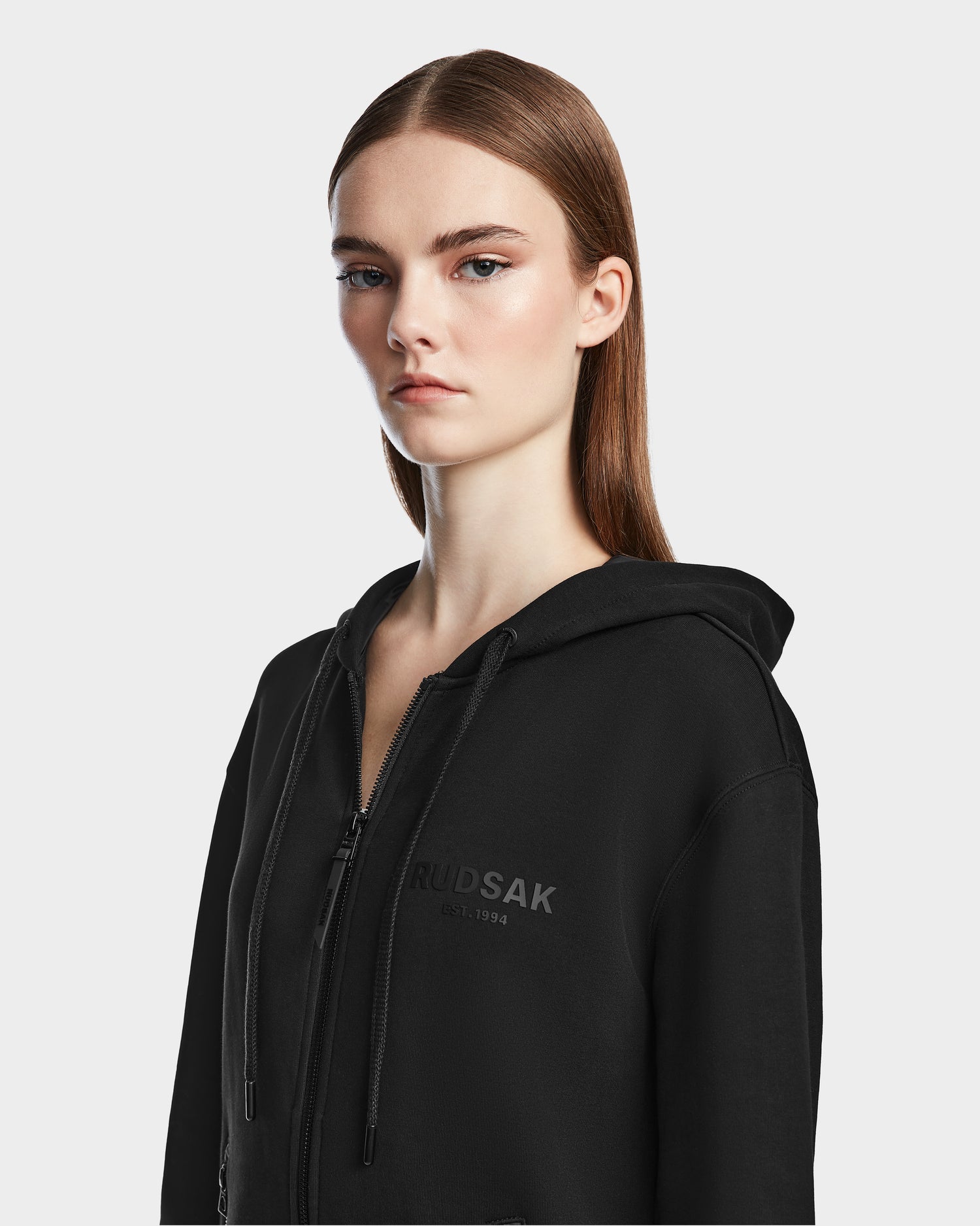 A woman wears the Rudsak JACE - 9524010 Black W hoodie.
