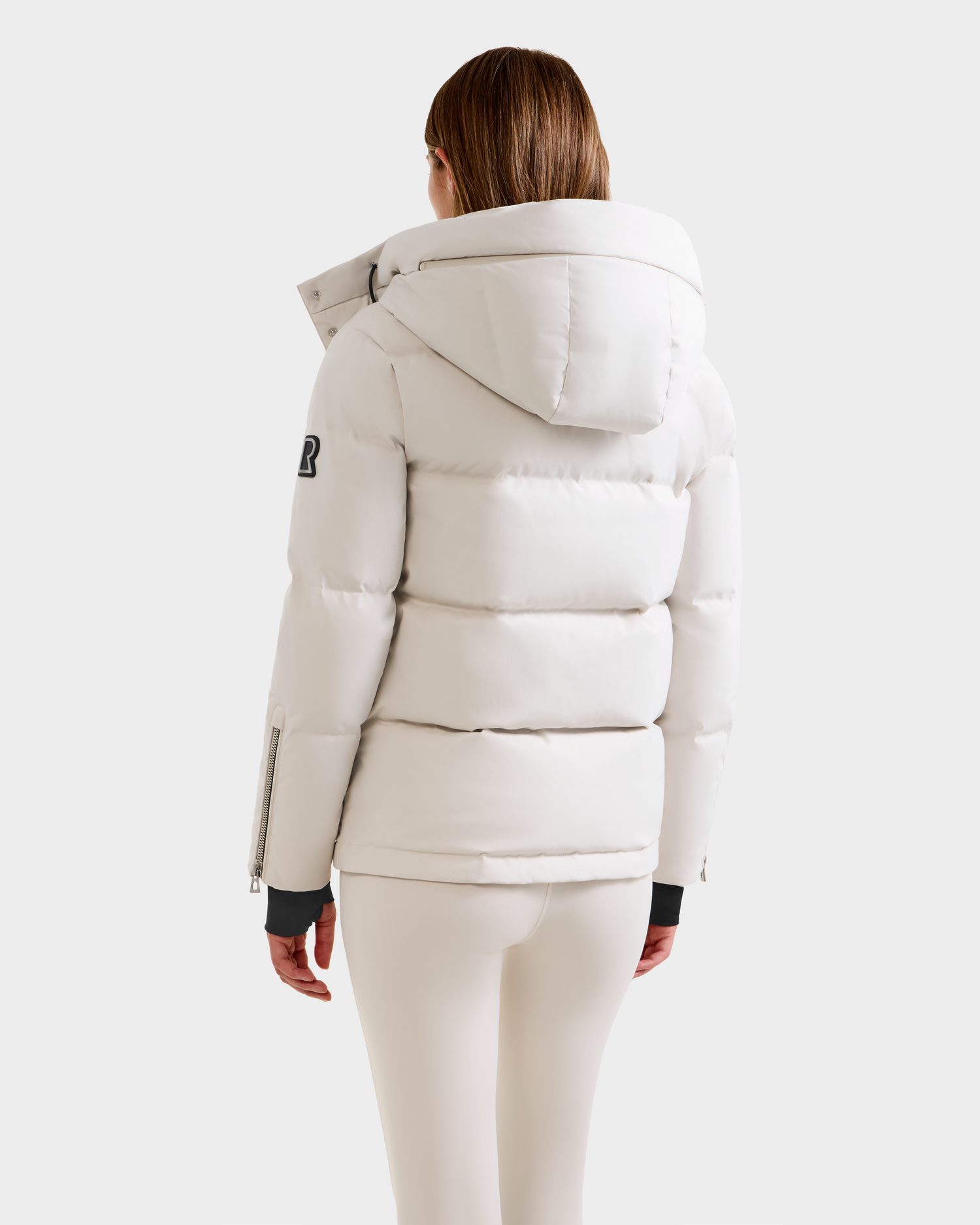 A person with straight, shoulder-length hair is seen from the back wearing the Rudsak JOON H - 8125586 Vanilla quilted winter jacket and matching pants against a plain light background.