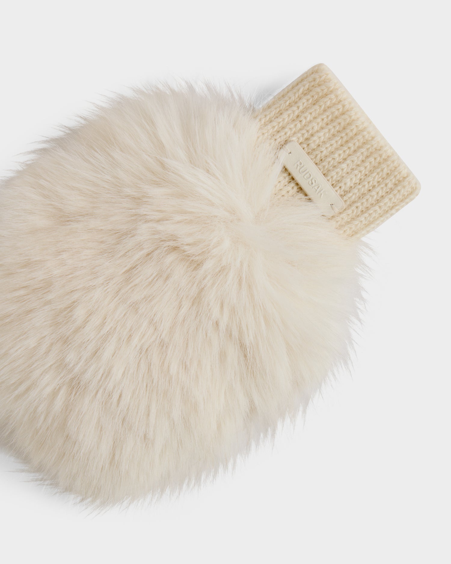 A close-up of the Rudsak LIA - 8425007 Vanilla women’s fingerless mitten, featuring a fluffy cream texture and ribbed wool-blend cuff, with a small branded tag, set against a plain white background.