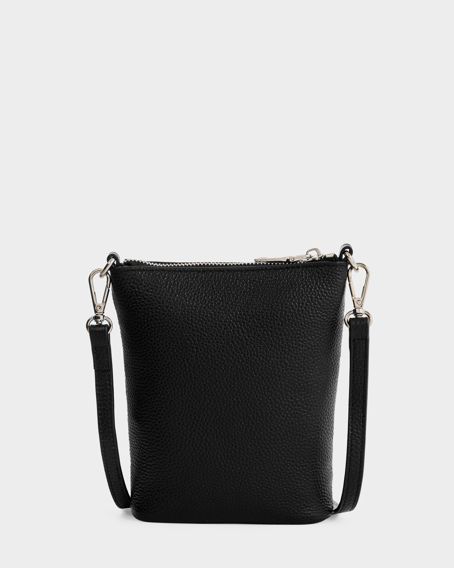 The Rudsak LILA - L325513 Black is a small women's crossbody bag in black pebbled leather, with a silver zipper closure and a detachable, adjustable strap, shown against a plain light background.