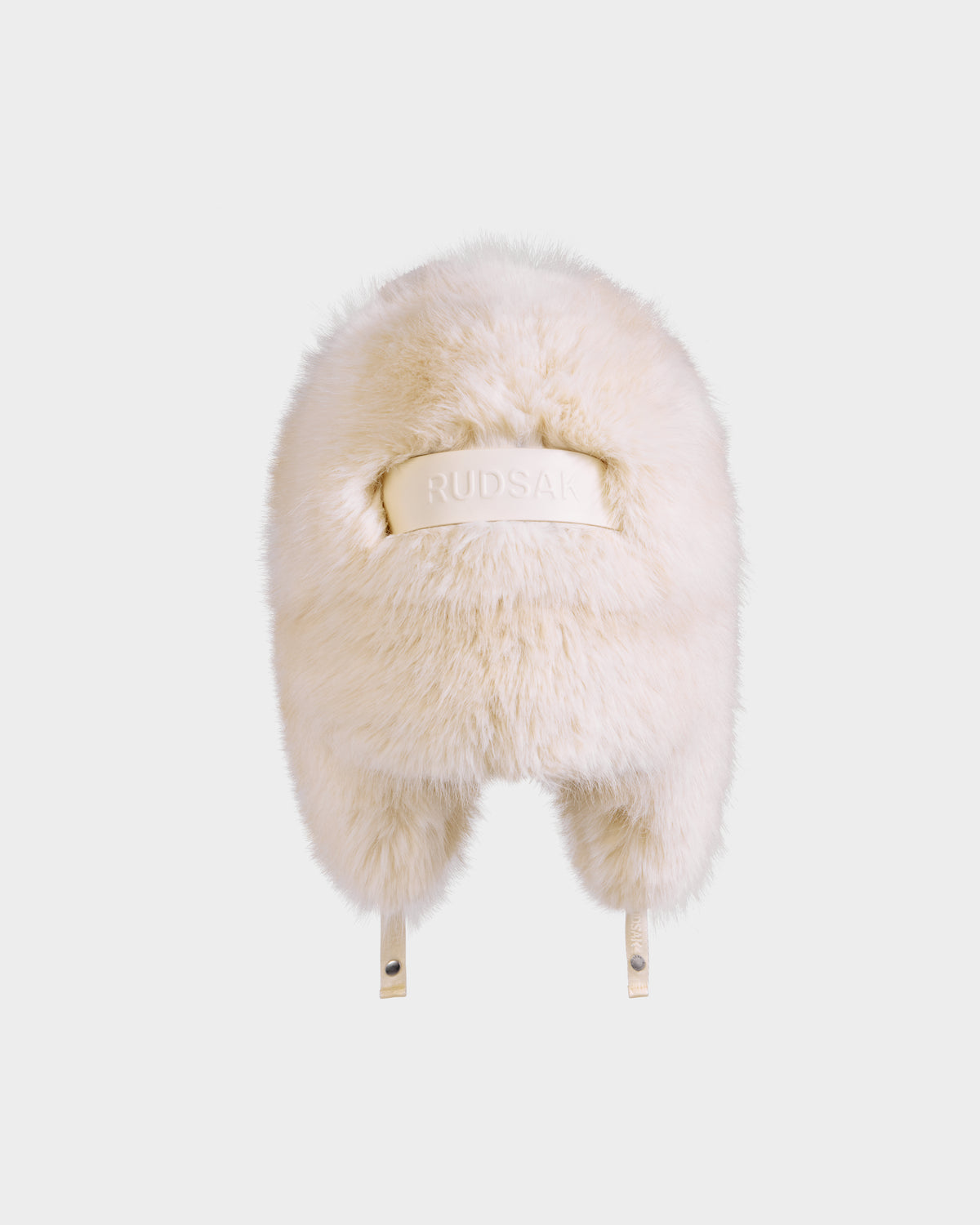 The LIRA - 8425024 Vanilla by Rudsak is a cream-colored women's faux fur aviator hat with ear flaps and a beige RUDSAK band, perfect for winter warmth, shown on a plain white background.