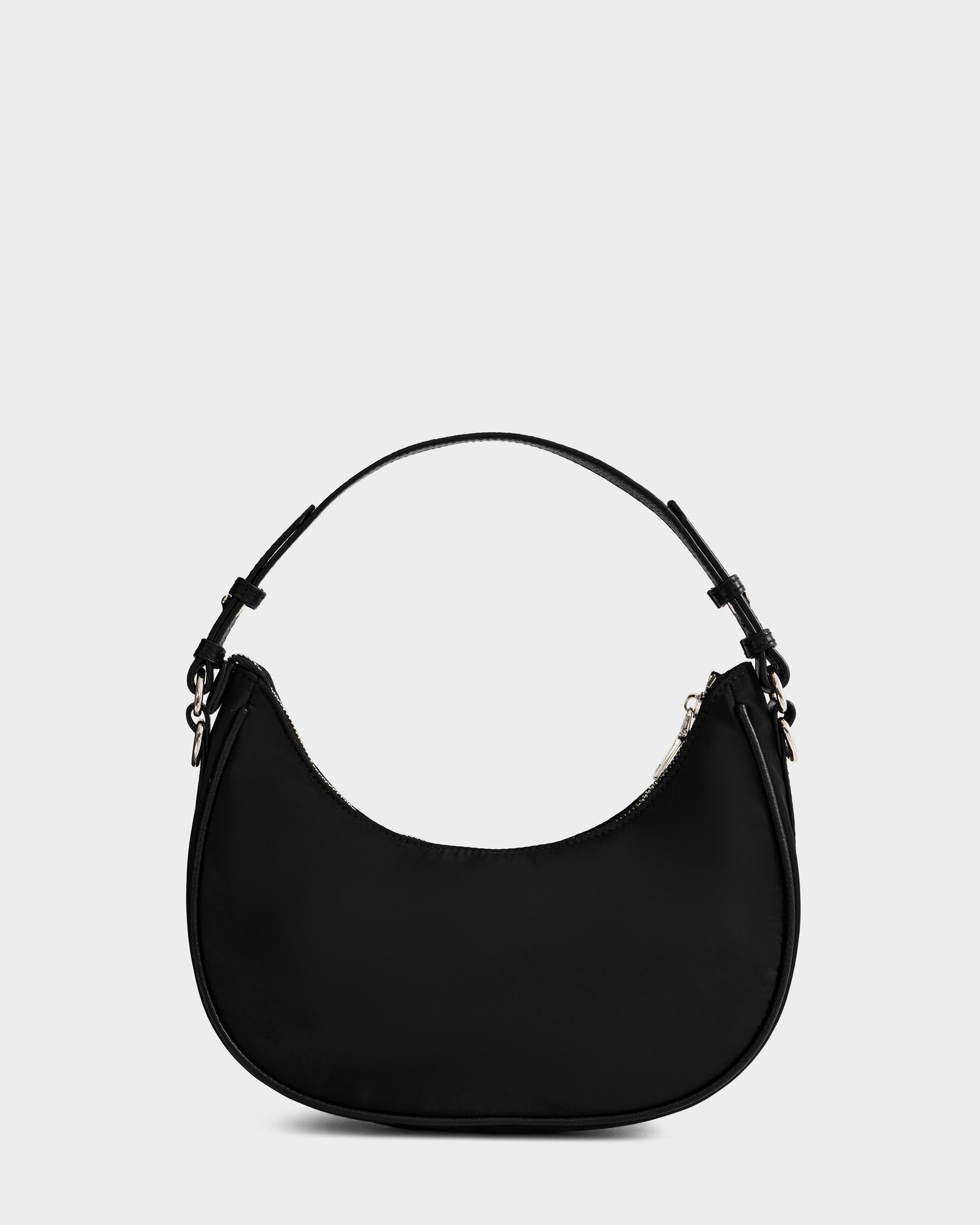 The Rudsak NIKKI - L325512 Black women’s crescent shoulder bag features a minimal design, chic hobo silhouette, and short strap, displayed against a plain light gray background.