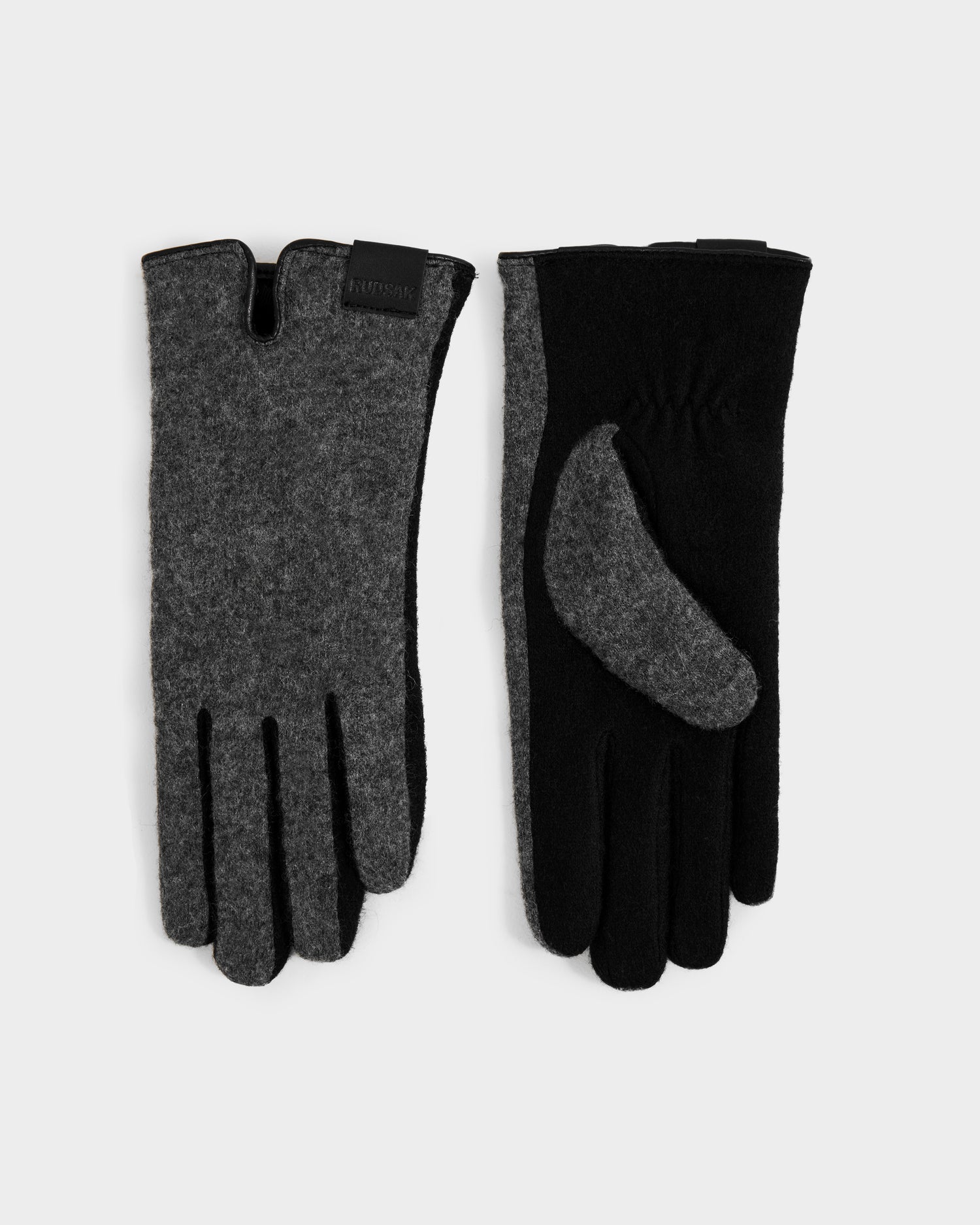 The OLGA - L425541 Grey women's wool gloves from Rudsak are shown on a white background; one reveals a grey thumb detail and the other displays a black logo patch, making them perfect for cold weather.