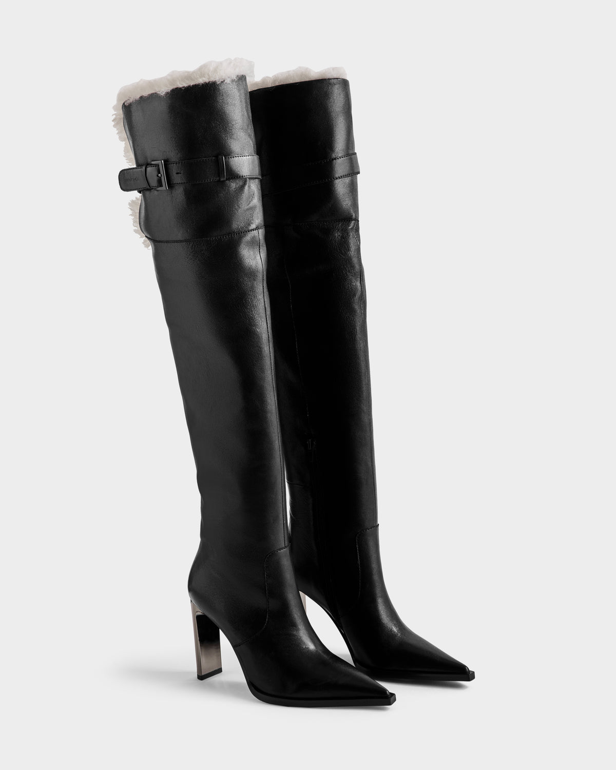 The PERNA - 8225555 Black boots by Rudsak feature tall black leather, pointed toes, high block heels, side buckles, and a white shearling cuff at the top.