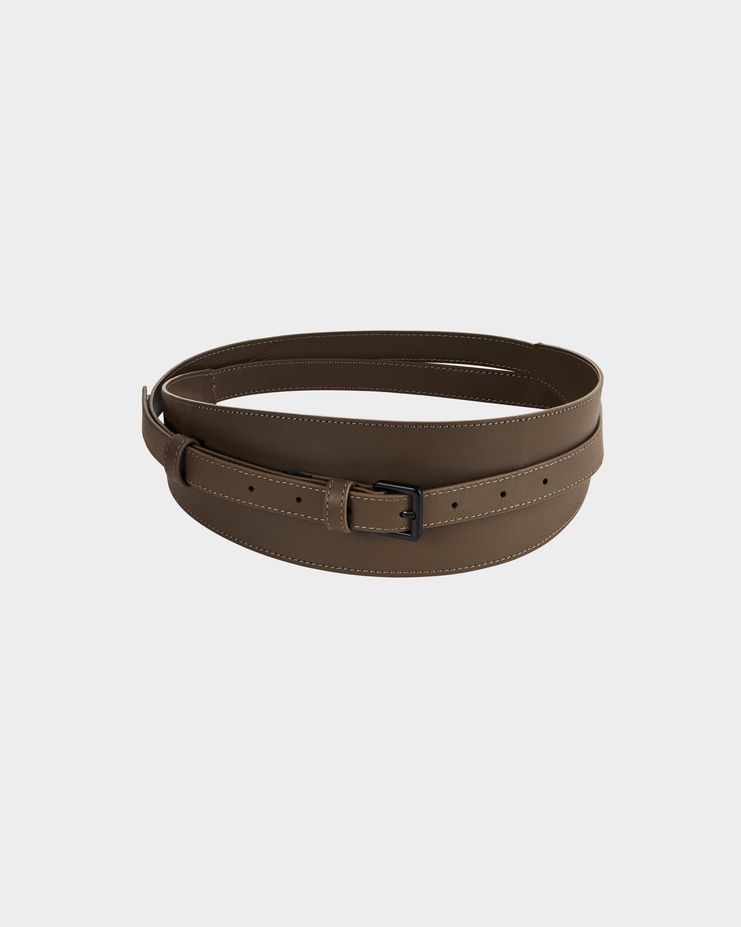 The Rudsak RENA - 8425039 Mocha is a brown leather belt with a matte black rectangular buckle, shown coiled on a plain white background.