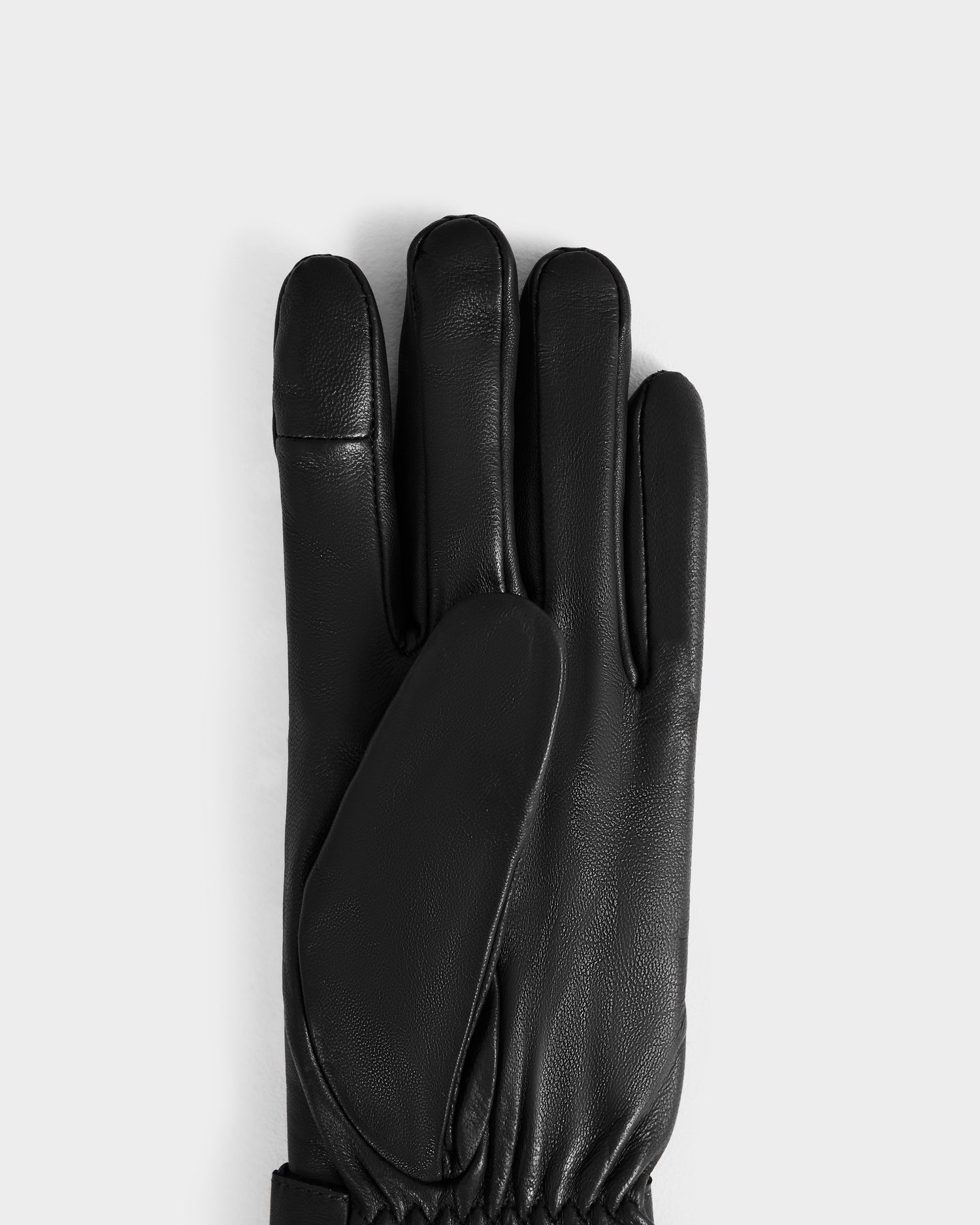 A single STROMBOLI - 8424510 Black women's leather glove by Rudsak is displayed palm down on a plain light gray background.