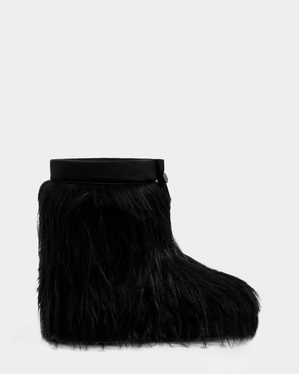 The SUZIE G - 8225545 Black boot by Rudsak features long, shaggy black faux fur and a smooth top band, shown against a light gray background—ideal for those seeking bold winter statement boots.