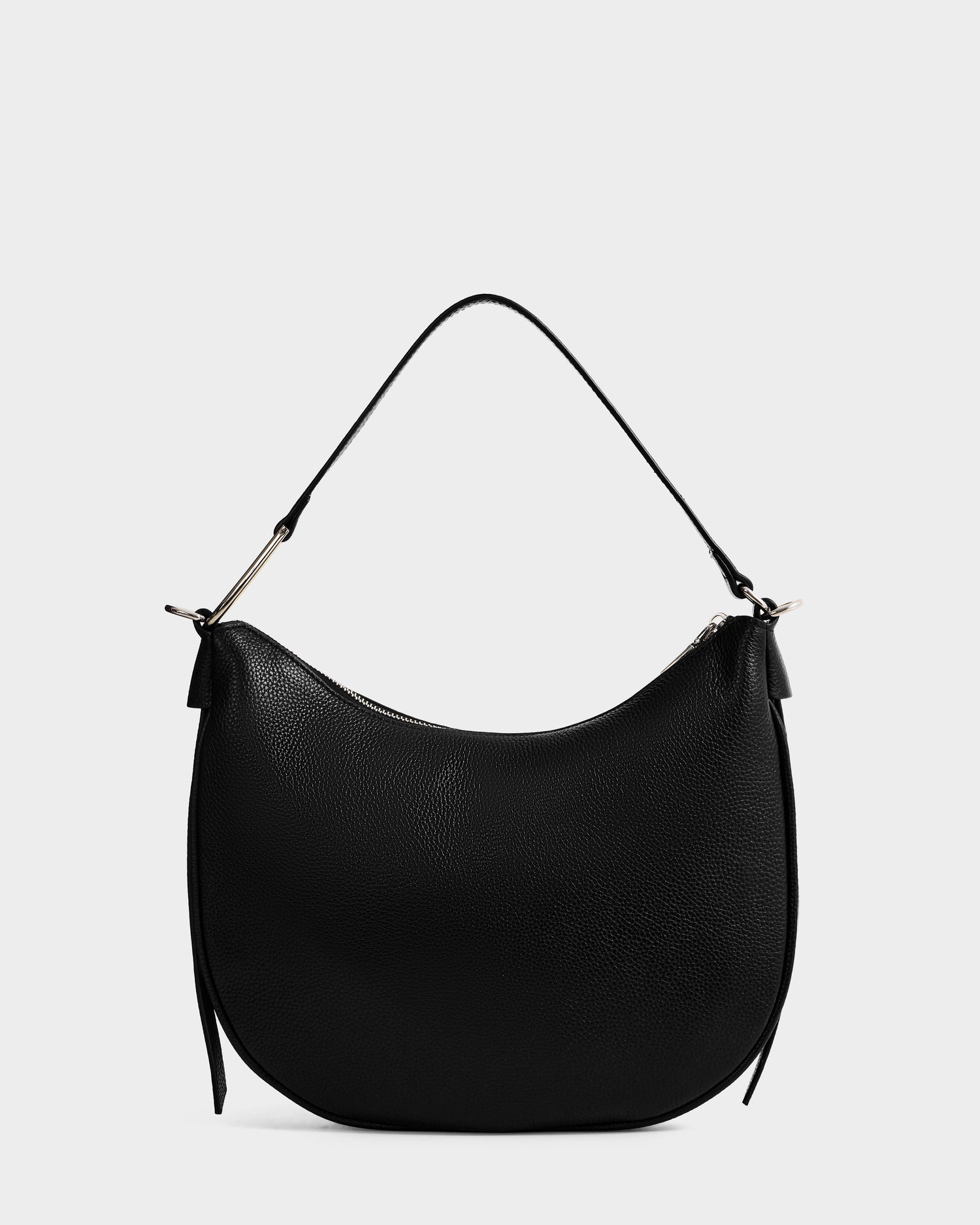 The Rudsak SYLVIA - L325515 Black is a black leather crescent silhouette bag with a short handle, silver hardware, and minimalist design, showcased against a plain white background.