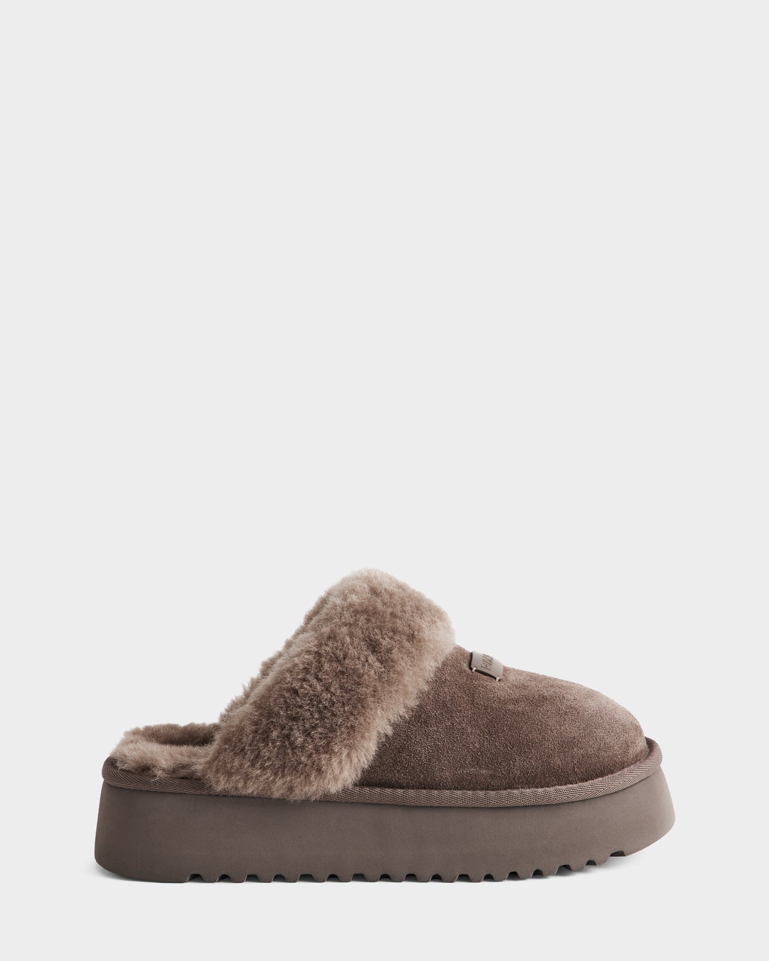 The Rudsak WILMA - 8225582 Mocha slipper features brown suede, a plush lining, and a sturdy platform sole, shown from the side on a plain white background.