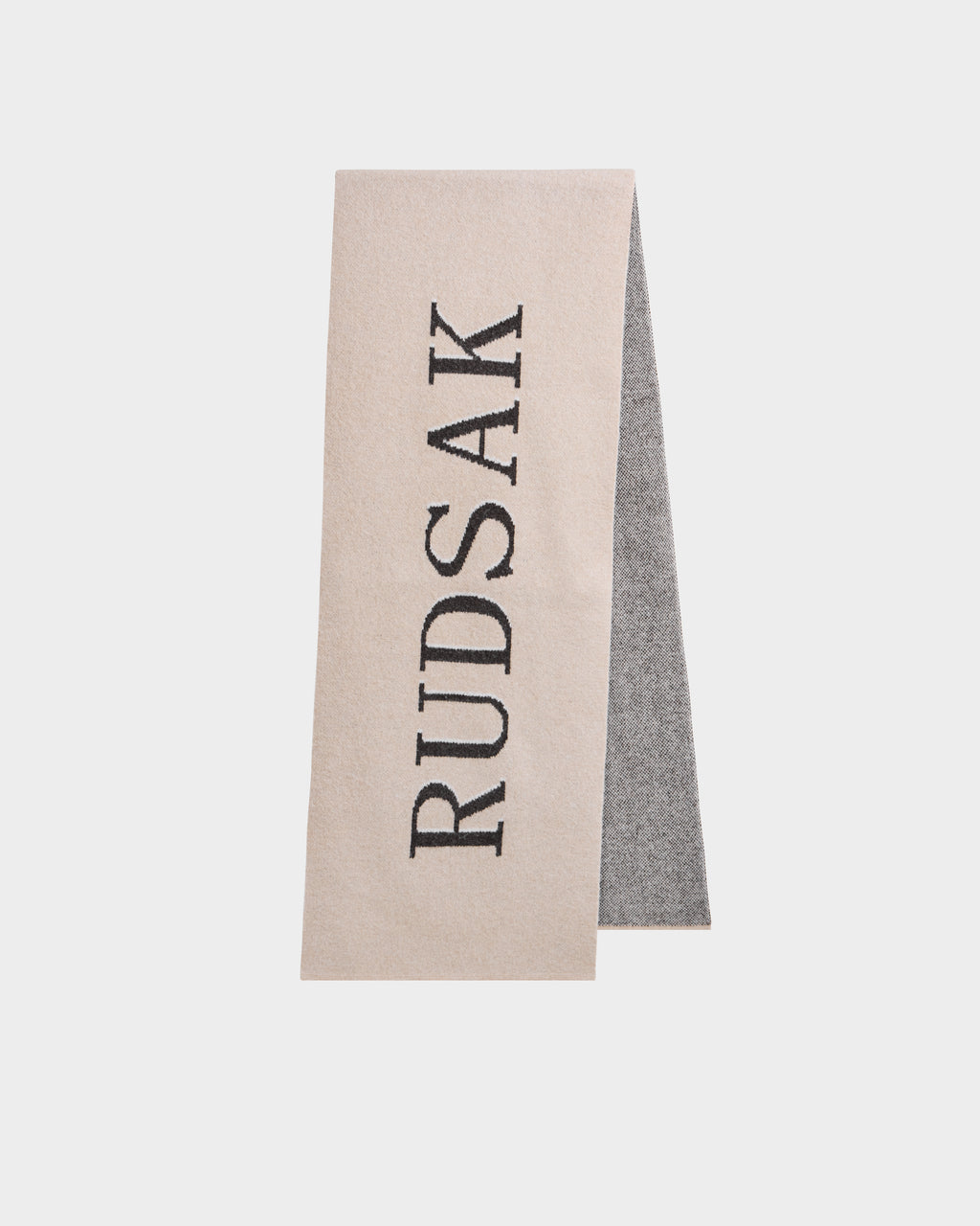 The WYATT - 6425039 Vanilla men's scarf by Rudsak features beige and gray tones with bold vertical black RUDSAK lettering—an essential cold-weather accessory to elevate your winter style.