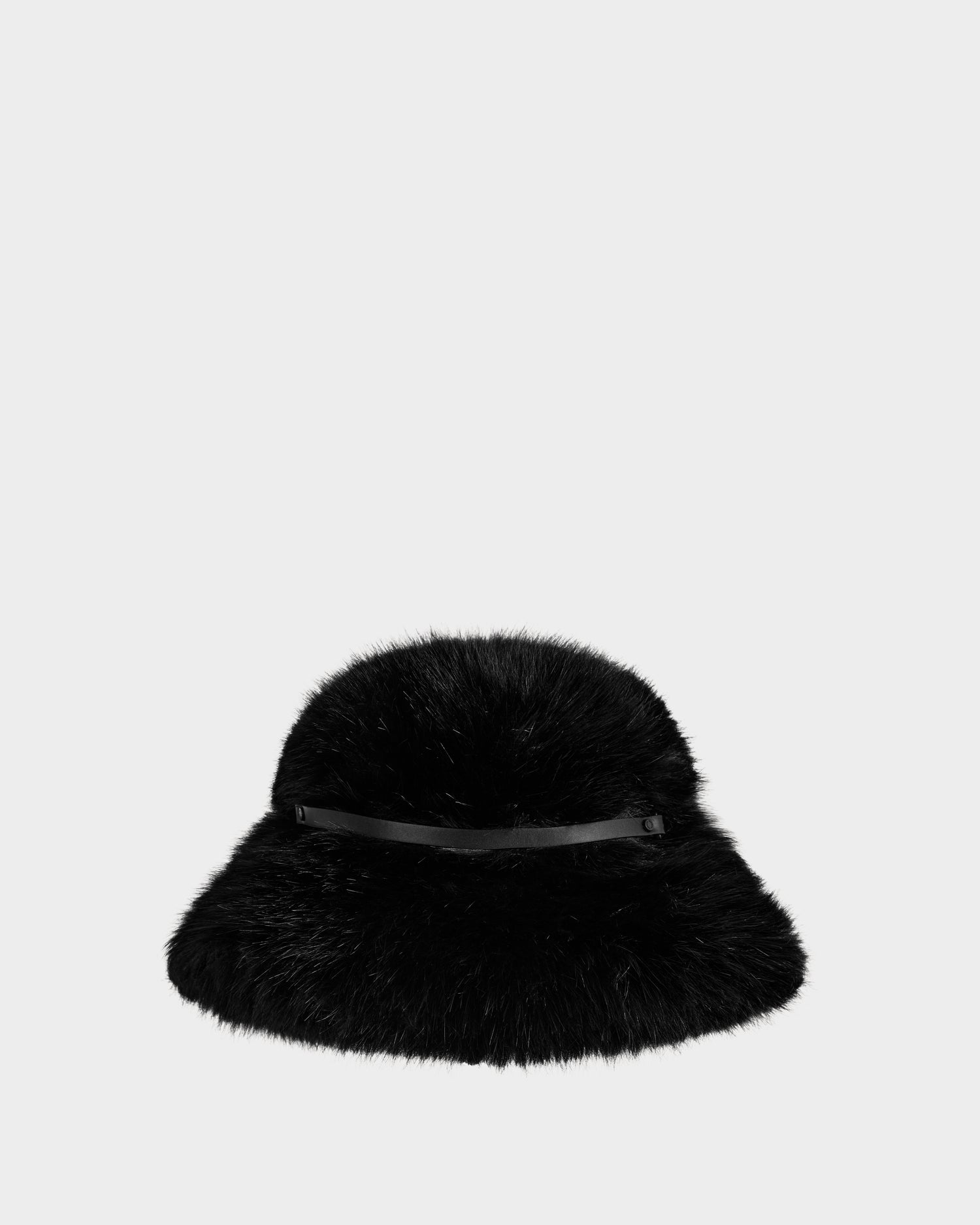 The YURI - L425538 Black by Rudsak is a women’s black faux-fur bucket hat featuring a wide brim and slim vegan-leather trim, shown on a plain light gray background—a stylish winter essential.
