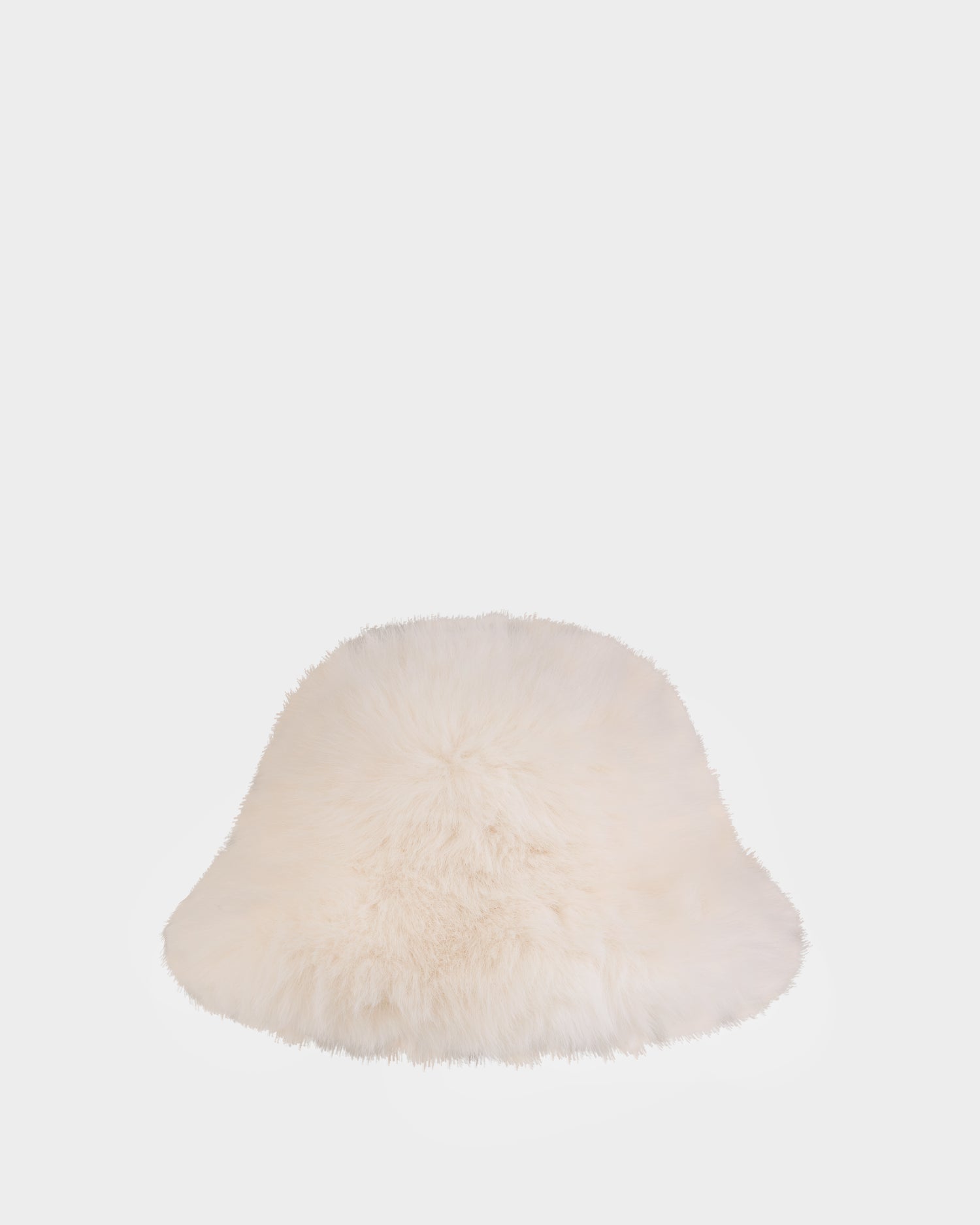 The Rudsak YURI - L425538 Iceland is a soft, white faux-fur bucket hat with vegan-leather trim, shown against a plain light gray background—a stylish women’s winter accessory.