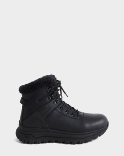 The BRYSON - 6226504 Black by Rudsak is a black leather winter boot with a lace-up design, thick lugged outsole, metal eyelets, black laces, and a fuzzy collar on a plain white background.
