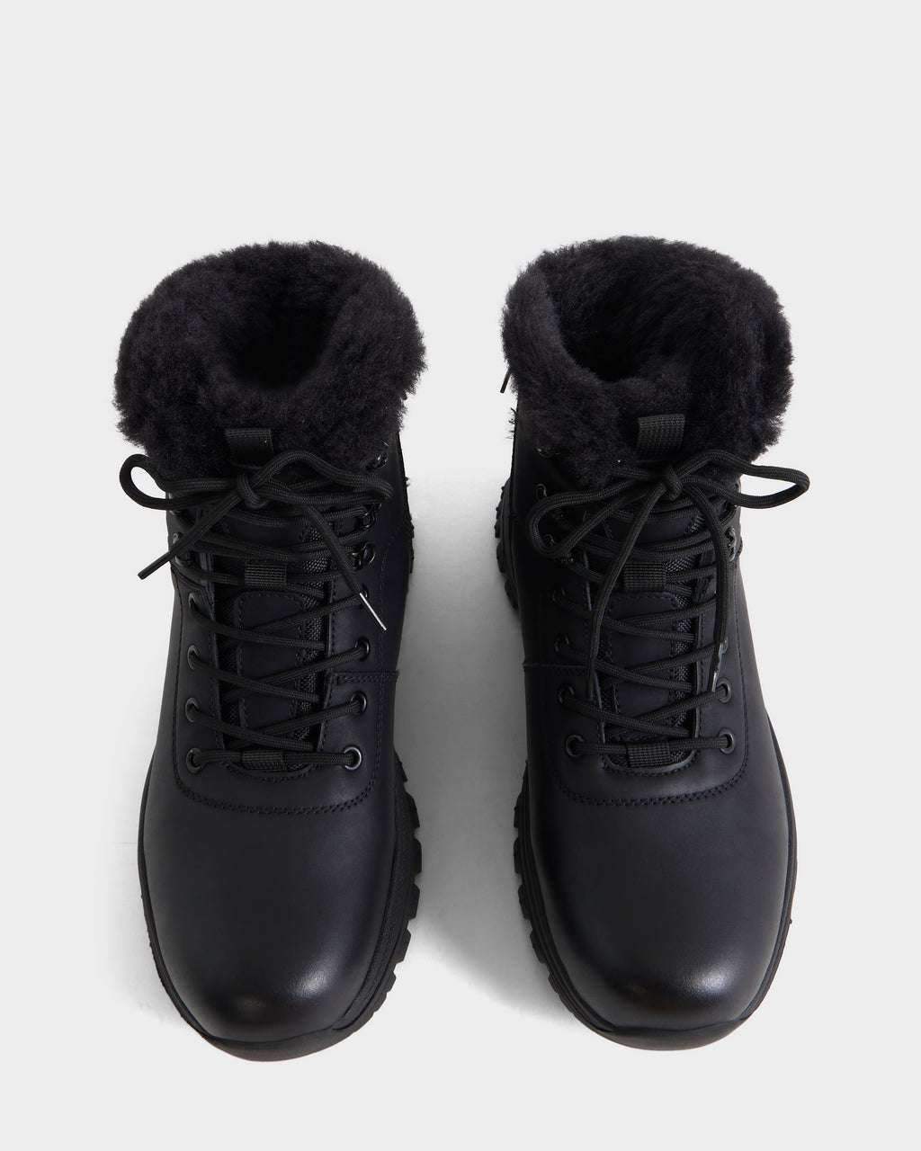 A pair of Rudsak BRYSON - 6226504 Black winter boots with black faux fur lining and lace-up design, shown from above on a plain white background.