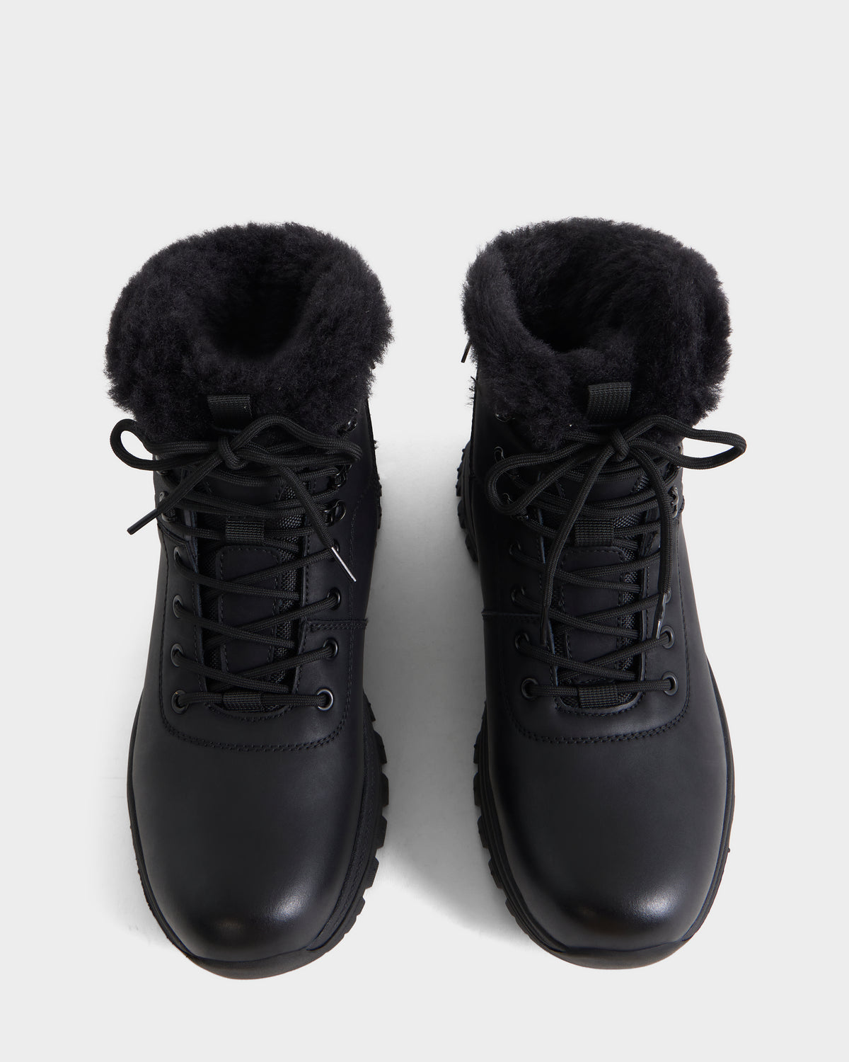 A pair of Rudsak BRYSON - 6226504 Black winter boots with black faux fur lining and lace-up design, shown from above on a plain white background.