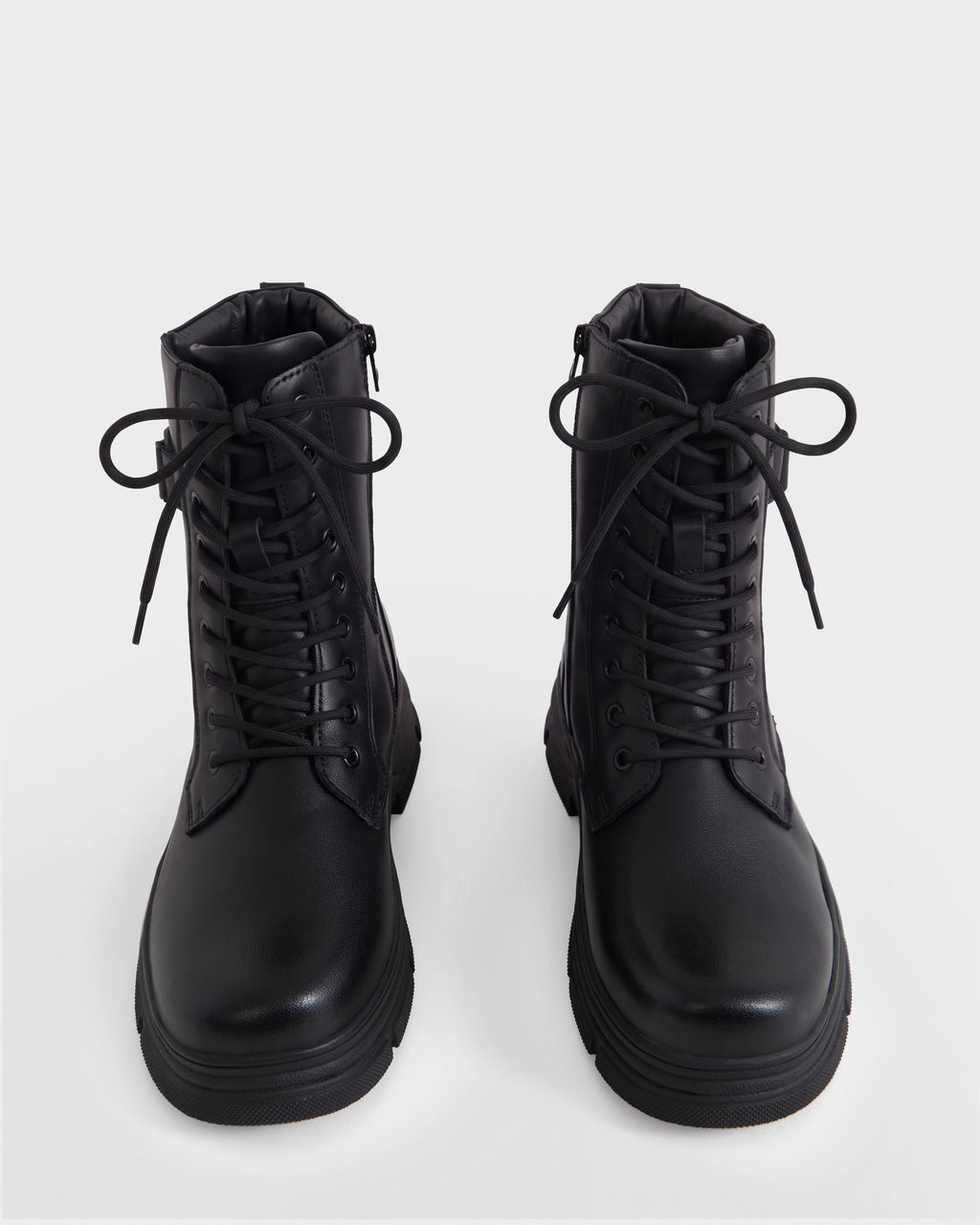 The DEREK - 6226506 Black by Rudsak: black combat boots with thick soles, perfect for winter, shown from the front against a plain white background.