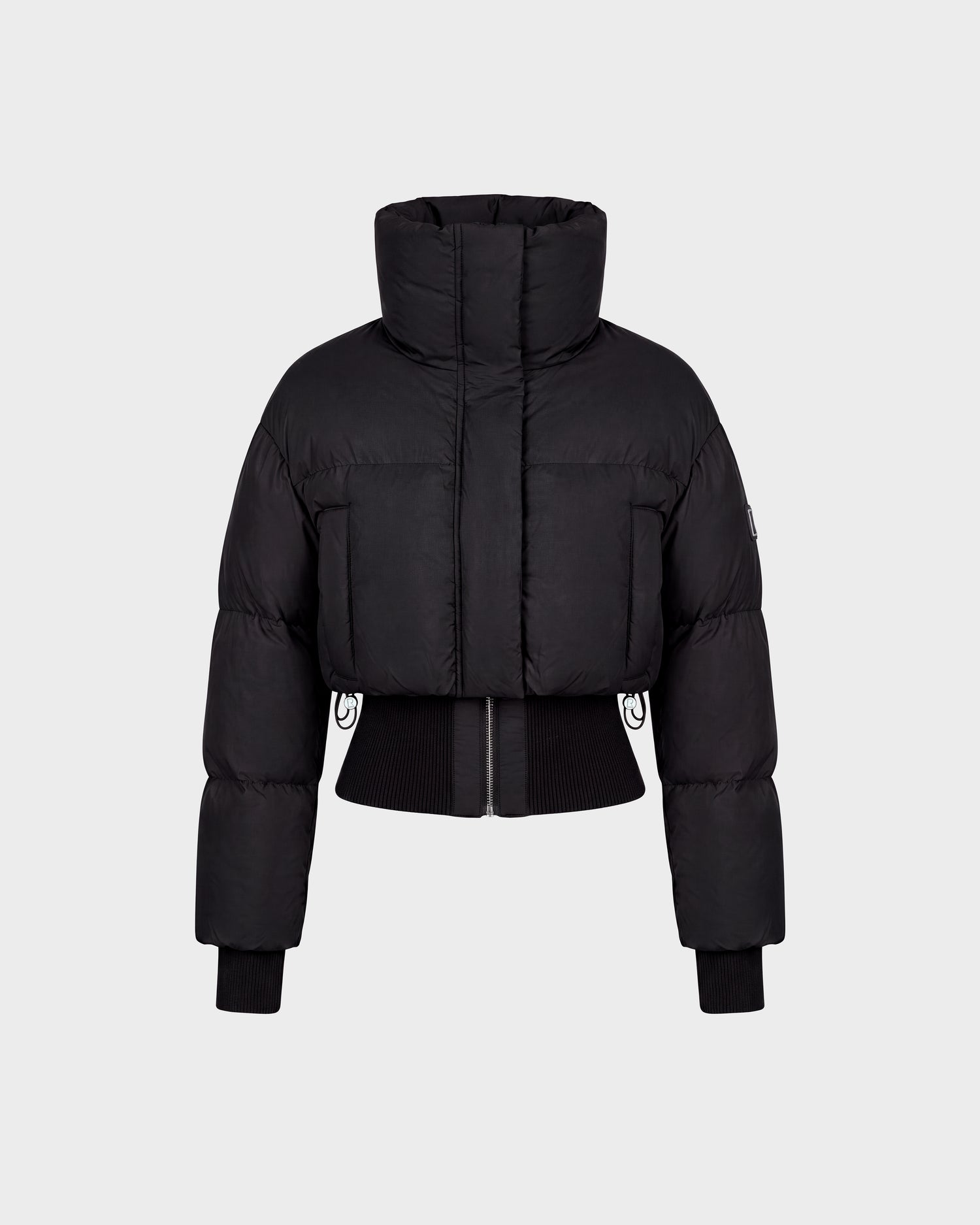 Rudsak DONYA - 8126516 Black cropped puffer jacket featuring a high collar, front zipper, ribbed cuffs, and waistband, displayed on a plain light gray background. Now available for pre-order; expected to ship by September 15th.
